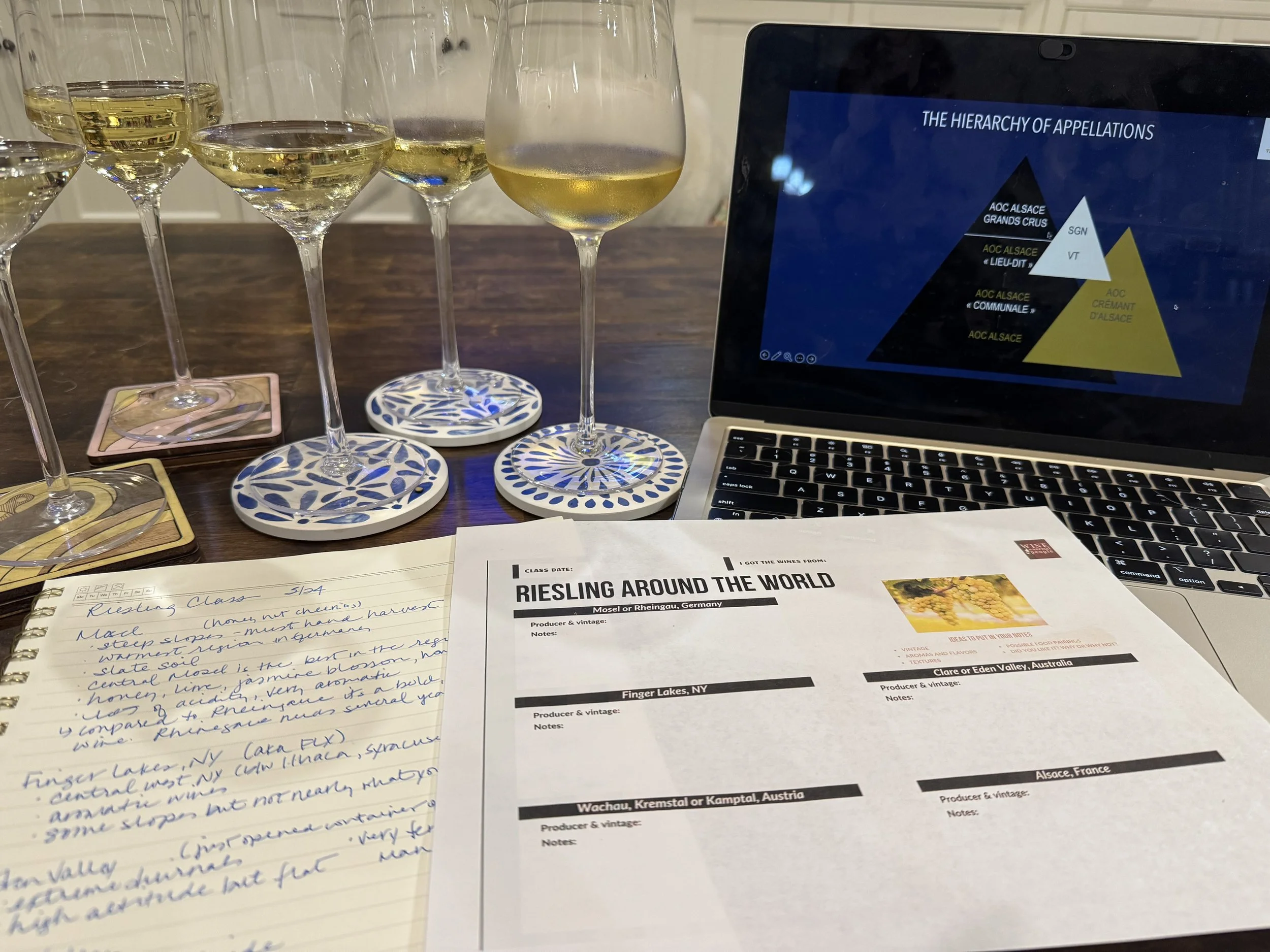 Wine education session with Riesling tasting notes, glasses, and a presentation.