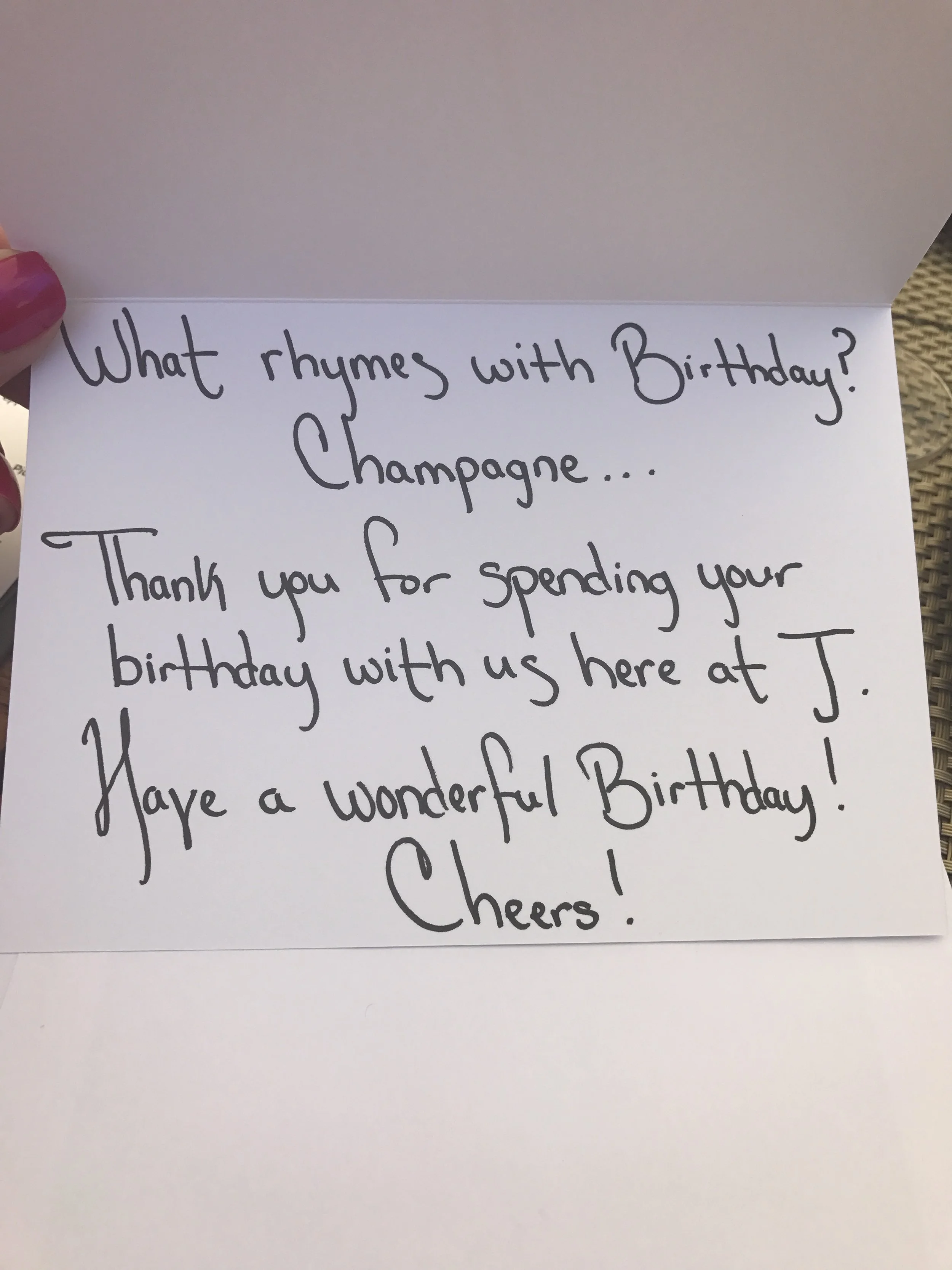 Handwritten birthday note celebrating with Champagne and a cheerful toast.