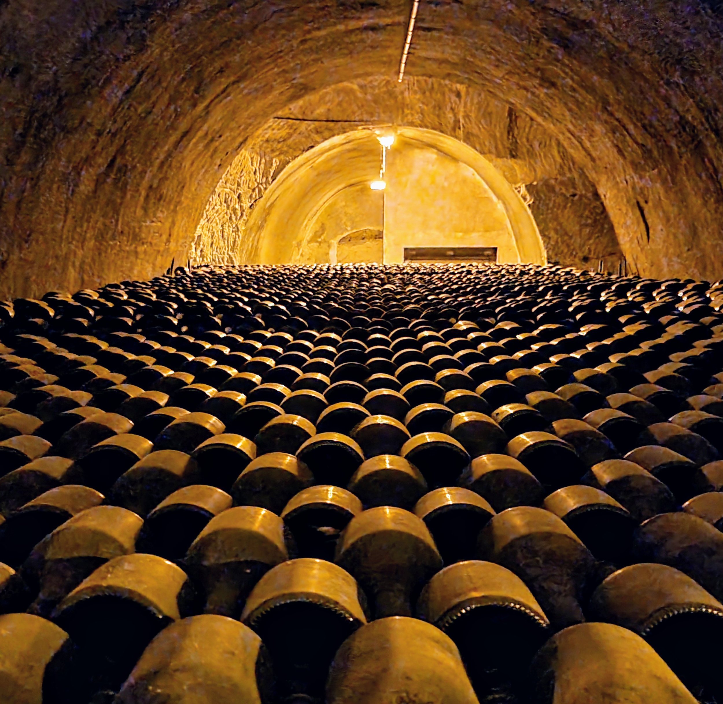 Bottles of Champagne aging in the Taittinger cellars in Reims, France.