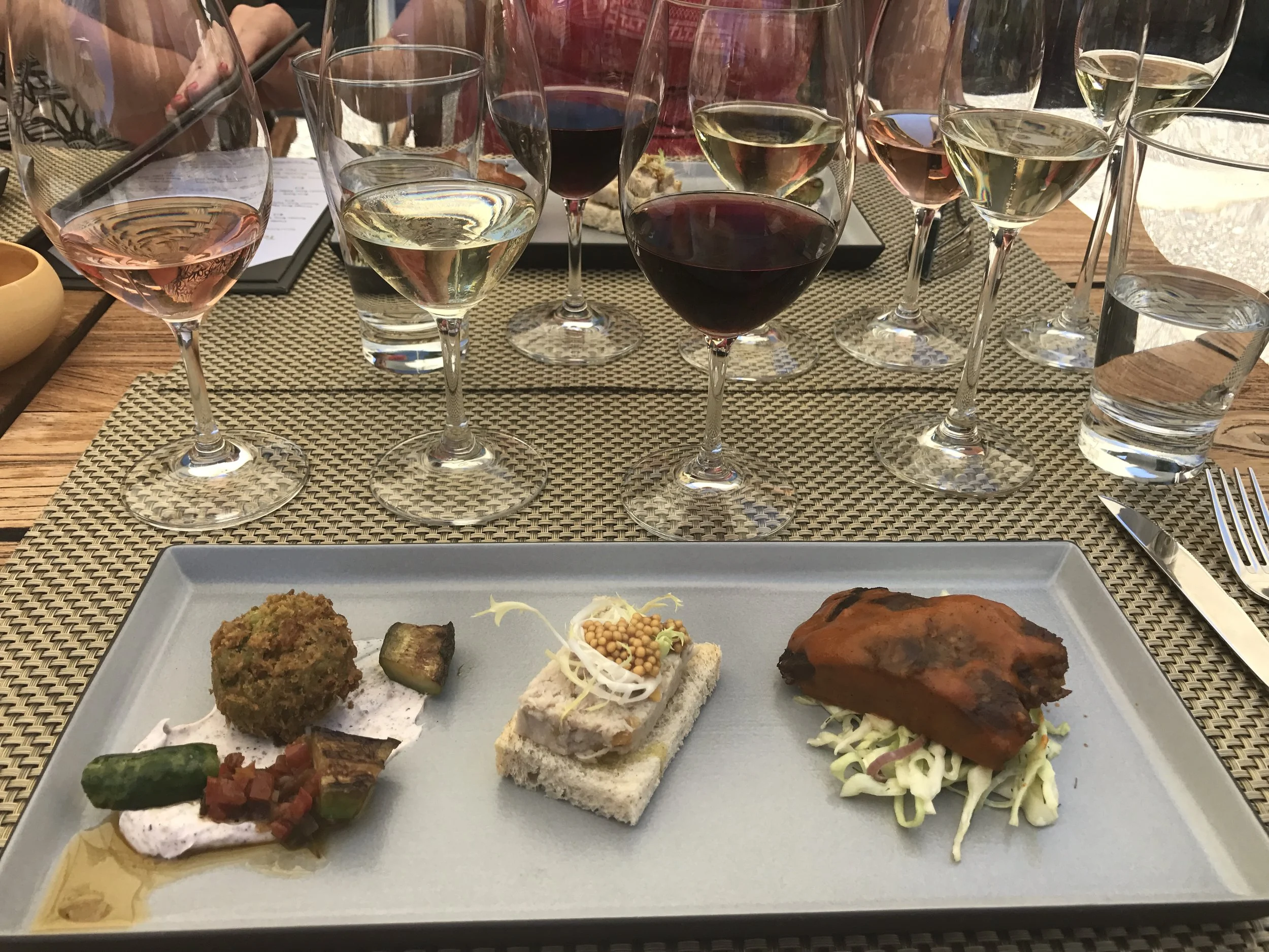Small plates paired with red and white wines during a wine tasting.