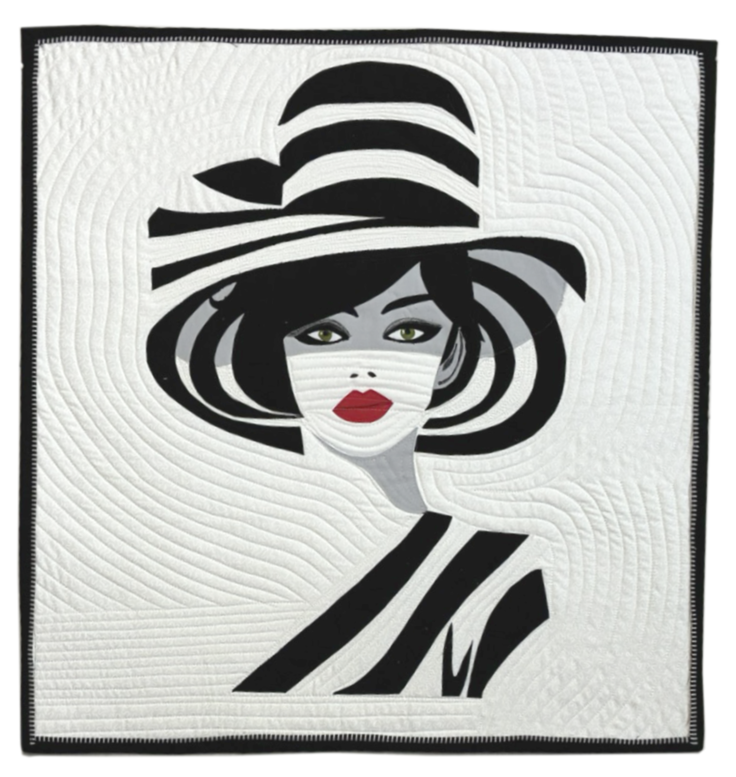 A quilt featuring a stylized woman with bright red lips, green eyes, and a black and white striped large-brimmed hat, all in an abstract, graphic style.