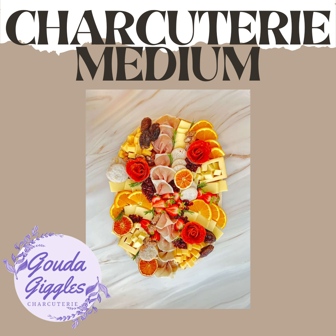 Medium charcuterie platter featuring cheeses, cured meats, strawberries, oranges, dried fruits, and garnishes.