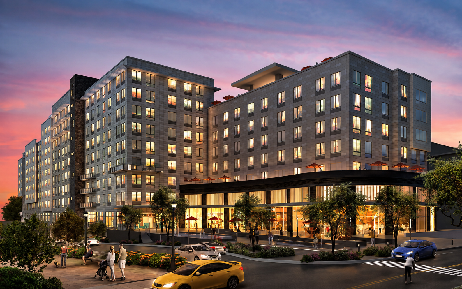 A modern multi-story residential and commercial building during sunset, with illuminated windows, a landscaped sidewalk with people, trees, parked cars, and outdoor seating with umbrellas.