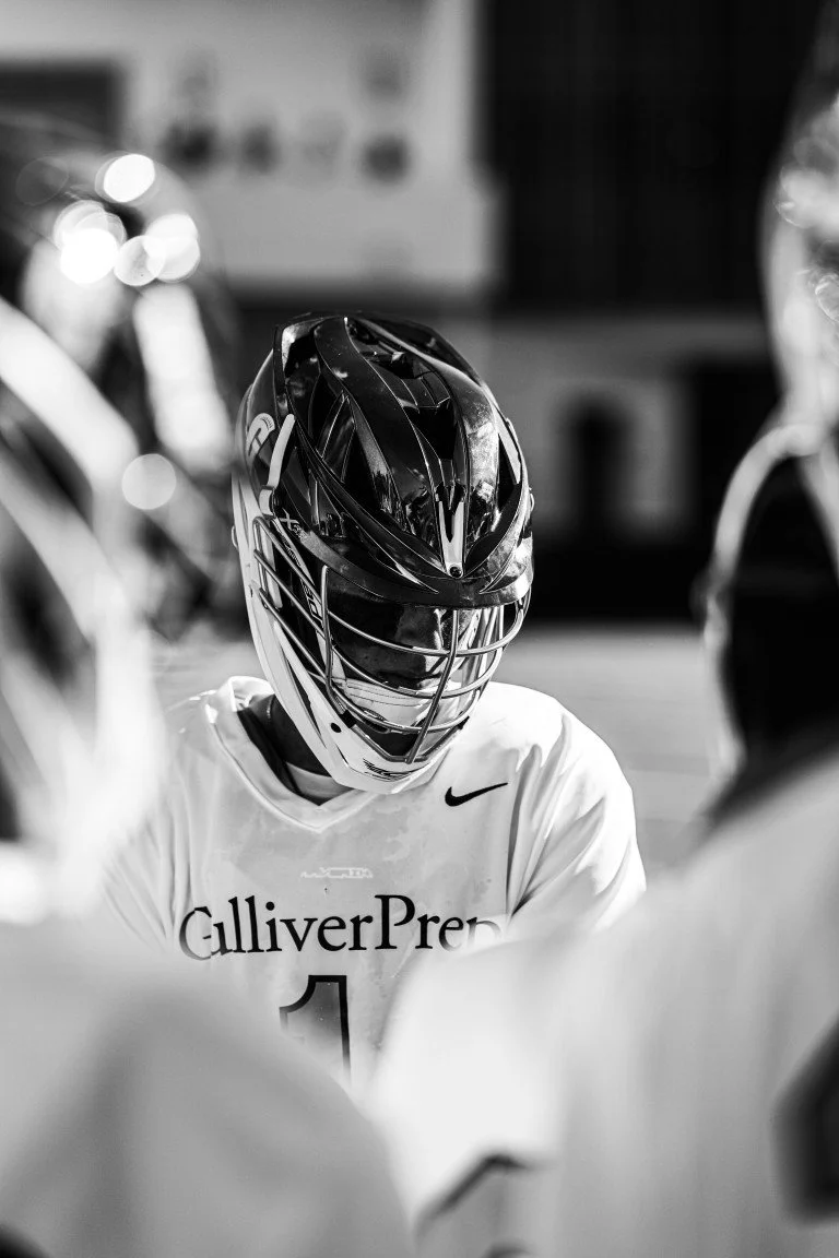 Lacrosse player wearing a helmet and jersey during a game