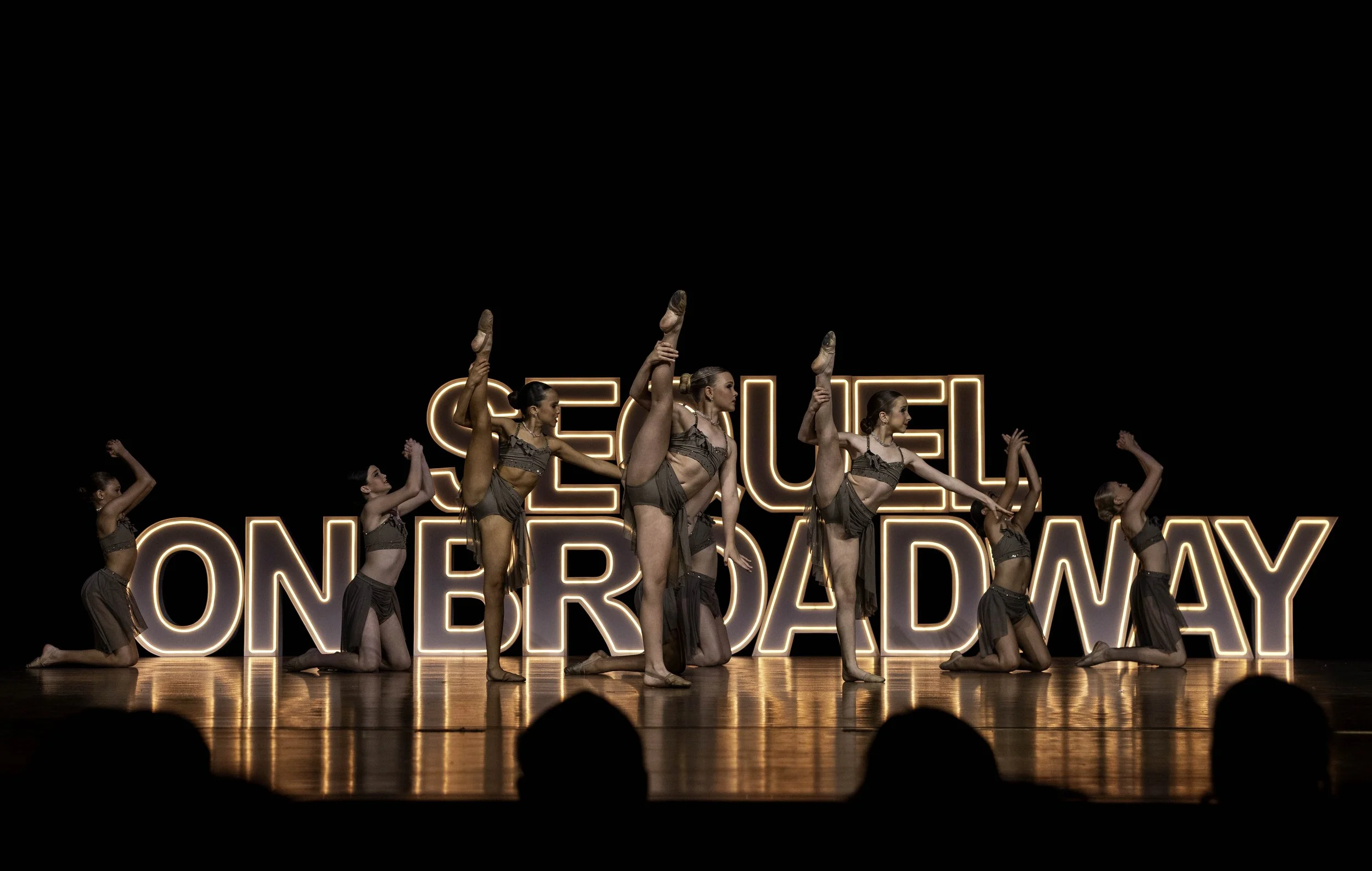 Costumed dancers performing contemporary choreography at Sequel Dance Complex recital