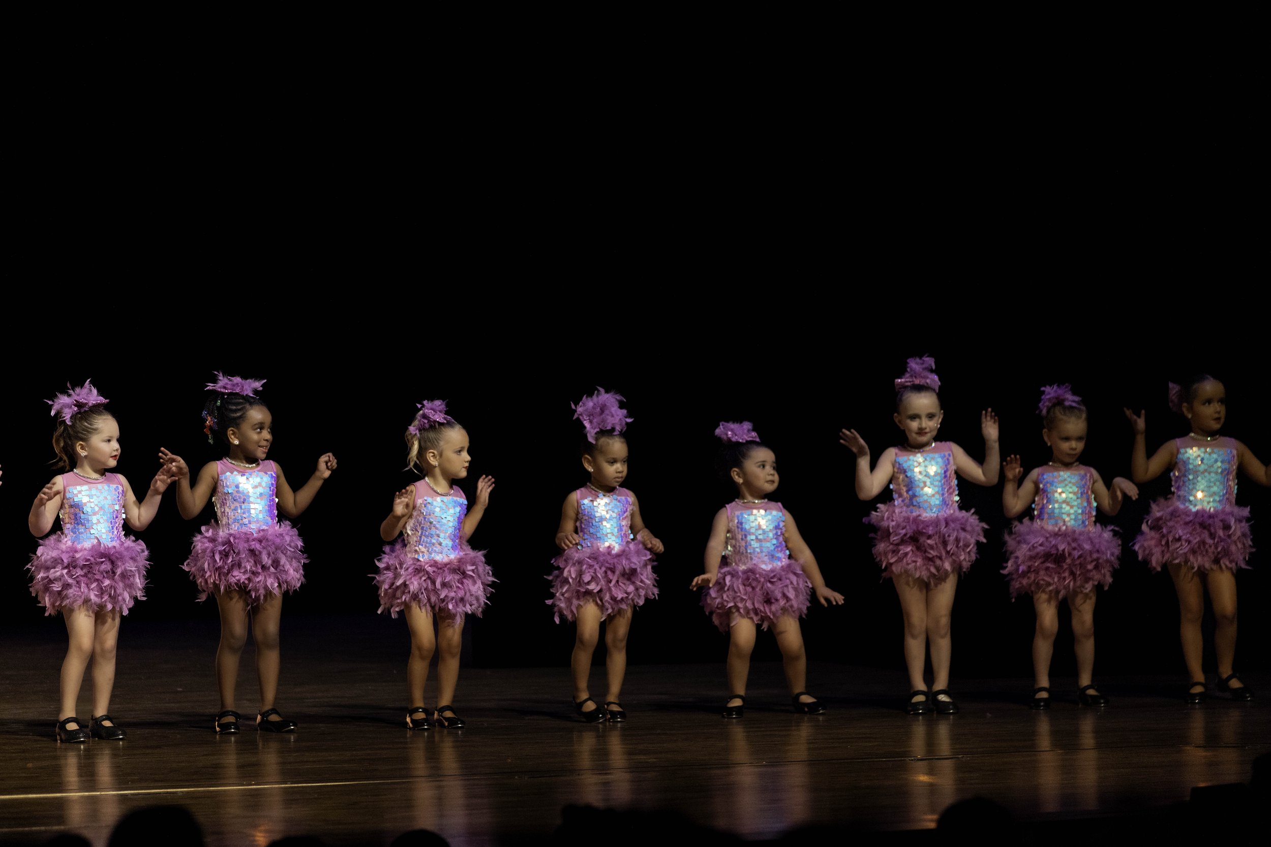 Young ballet dancers on stage during Sequel Dance Complex's recital performance