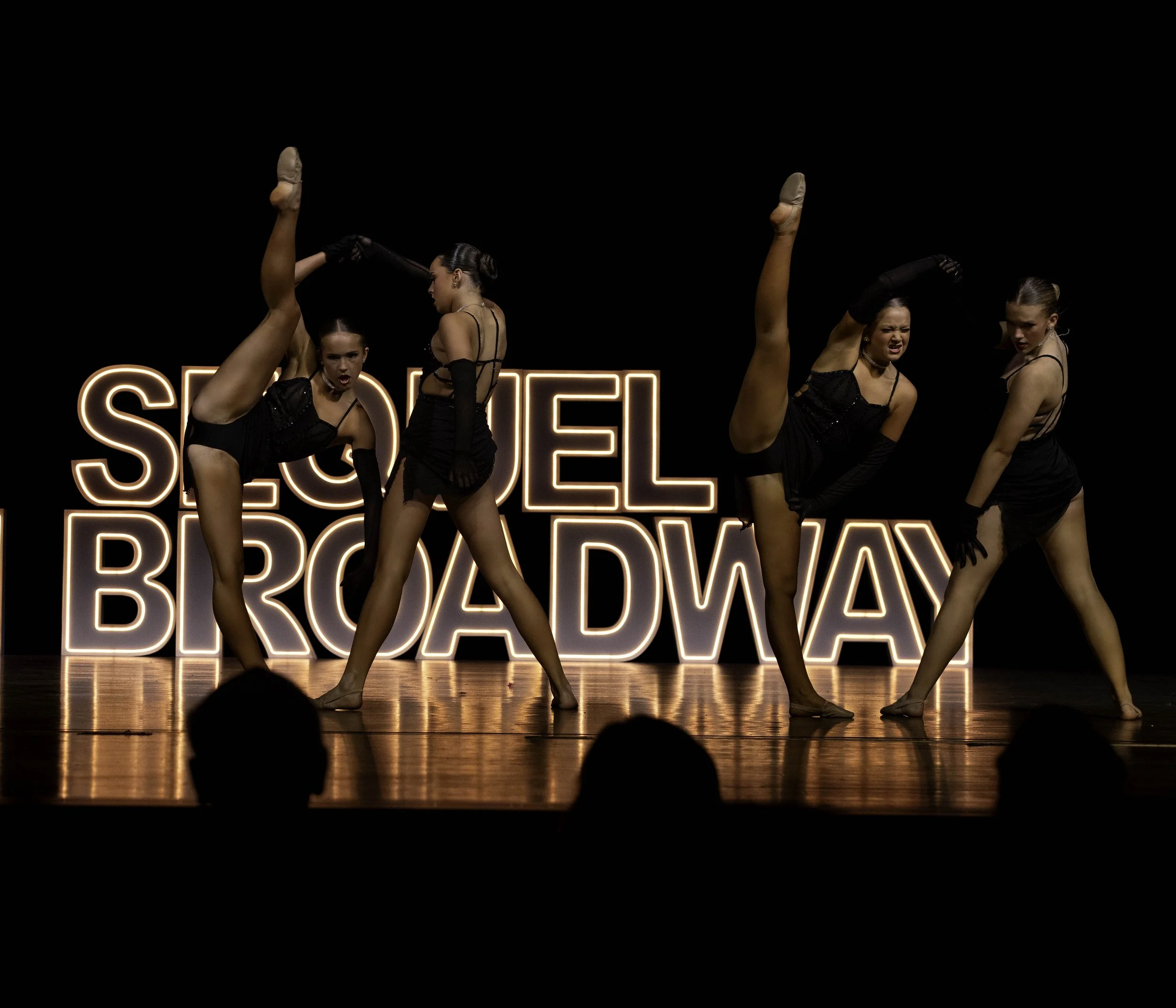 Young ballet dancers on stage during Sequel Dance Complex's recital performance