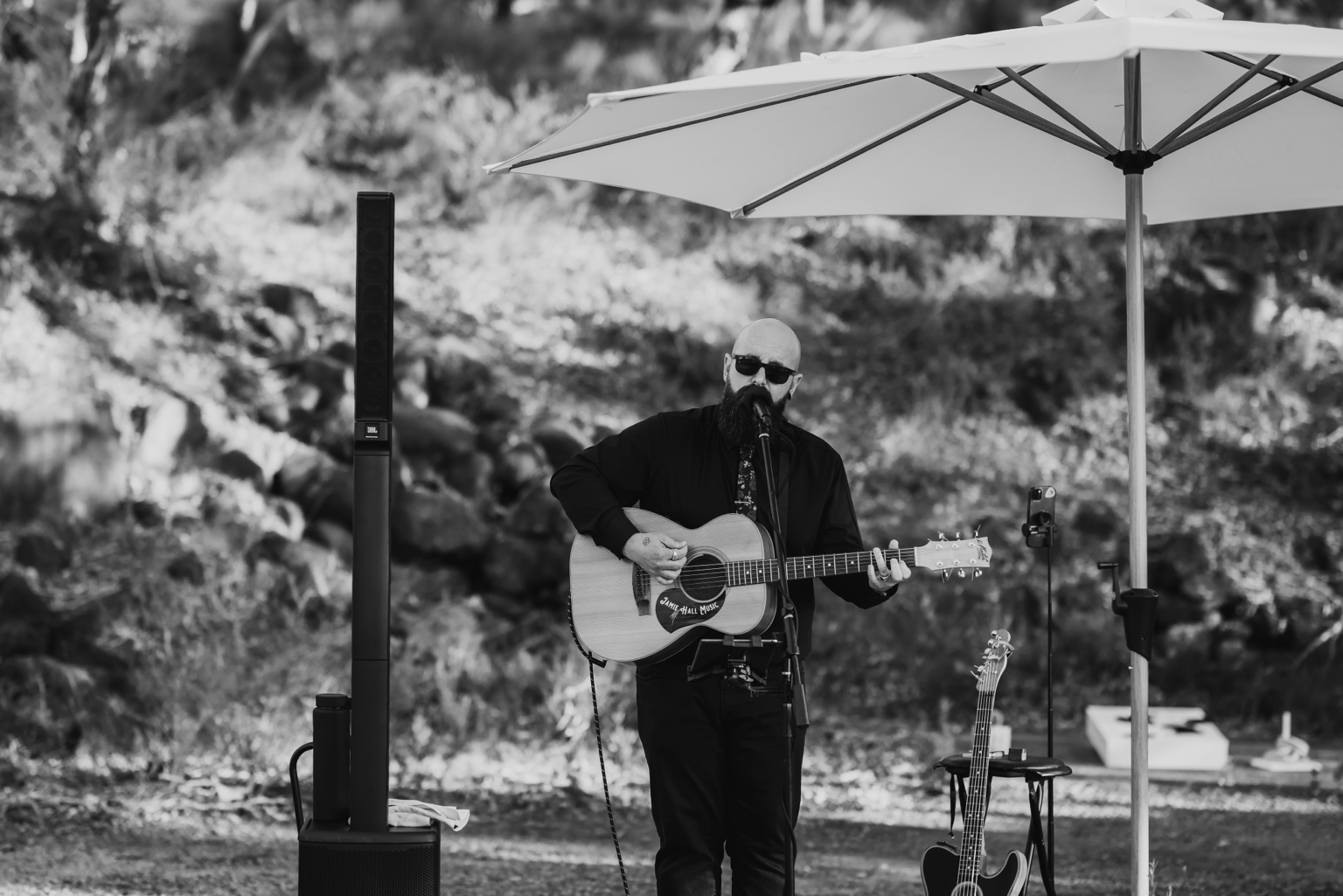 Jamie Hall performing acoustic music at an outdoor wedding in Western Australia