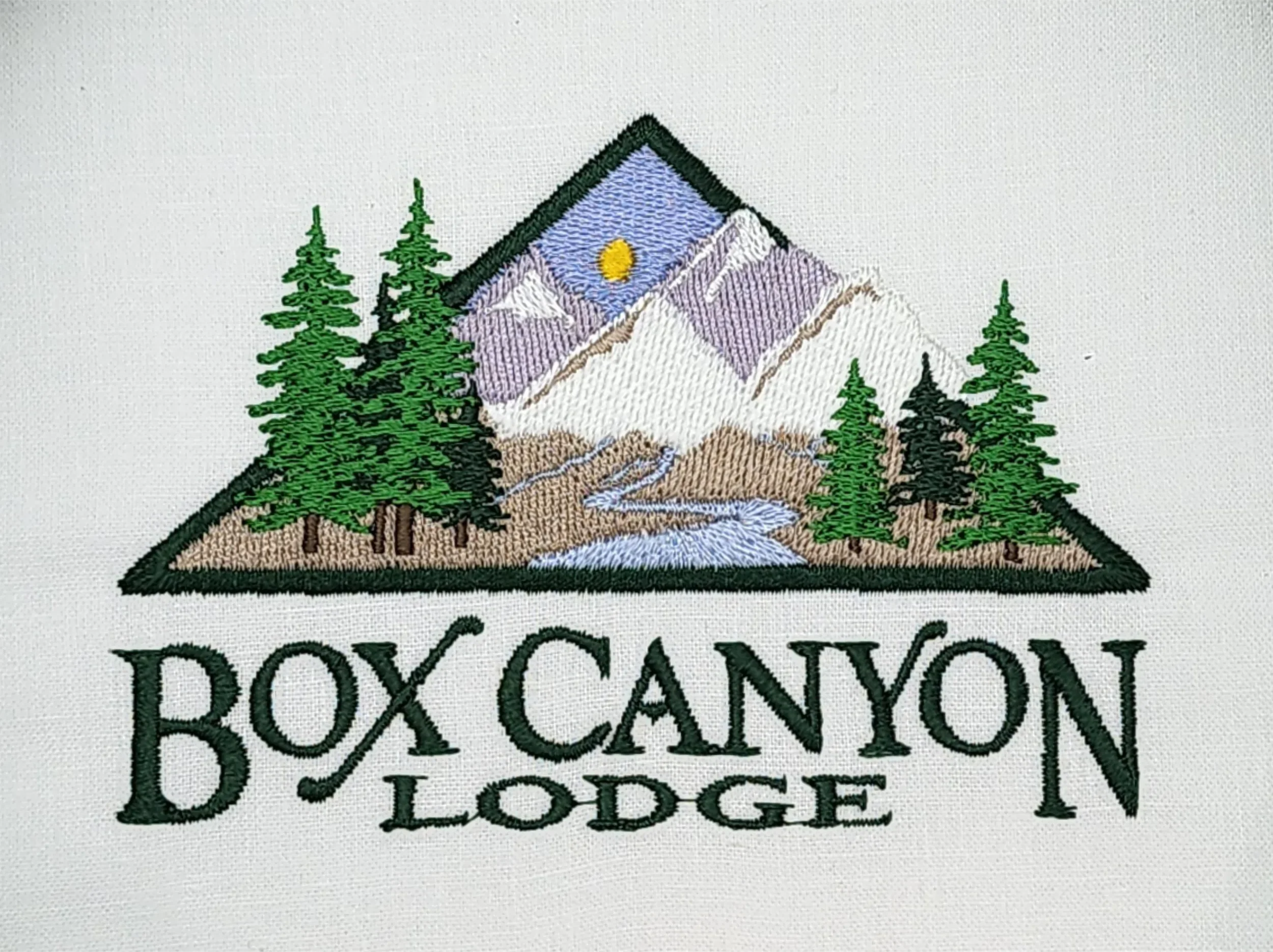 Full color custom hand digitized embroidered logo for Box Canyon Lodge caps and polos.