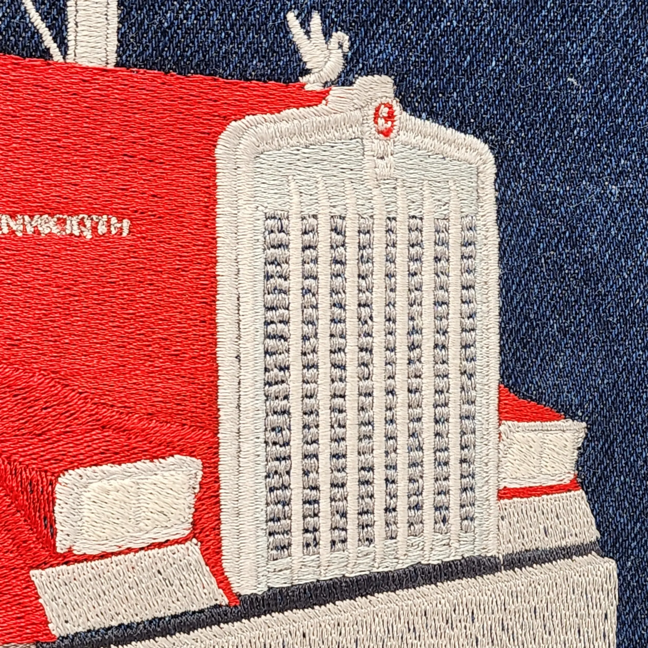 Image of the grill detail of Red Semi-truck jacket back custom embroidery.