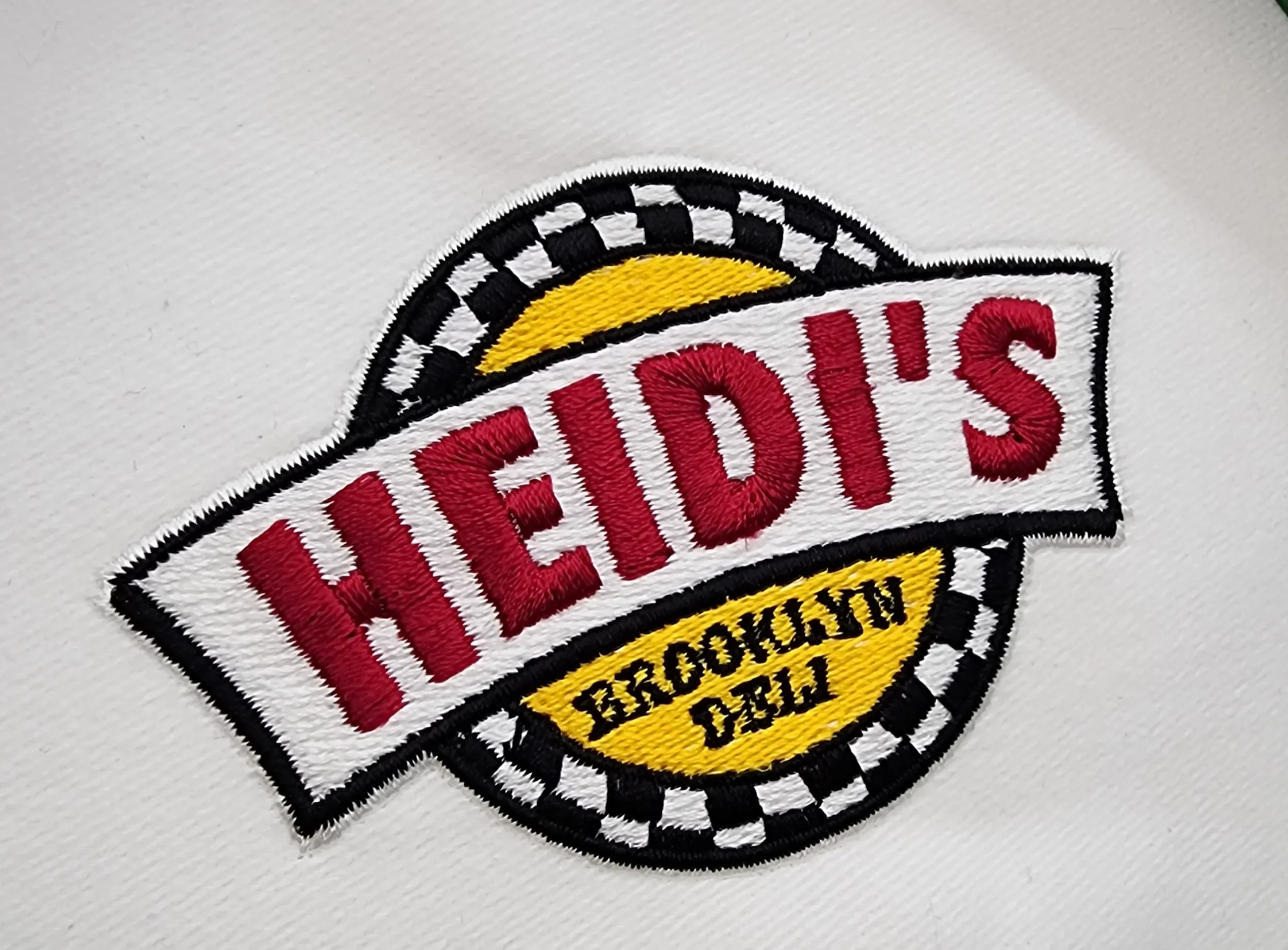 Custom hand digitized staff uniform embroidery for Heidi's Brooklyn Deli.