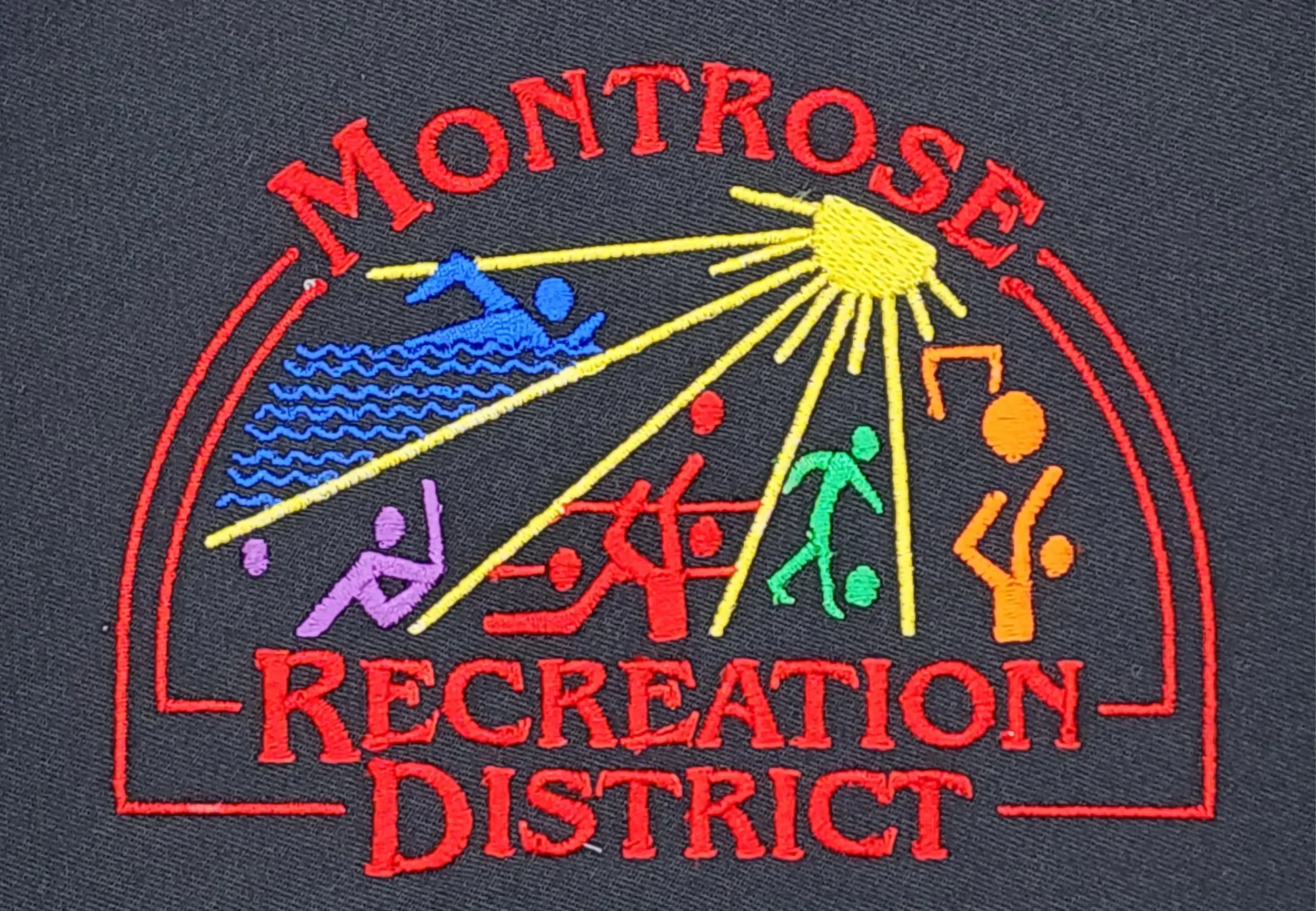 Custom embroidery of Montrose Rec District logo for woven shirts, hoodies and polos.
