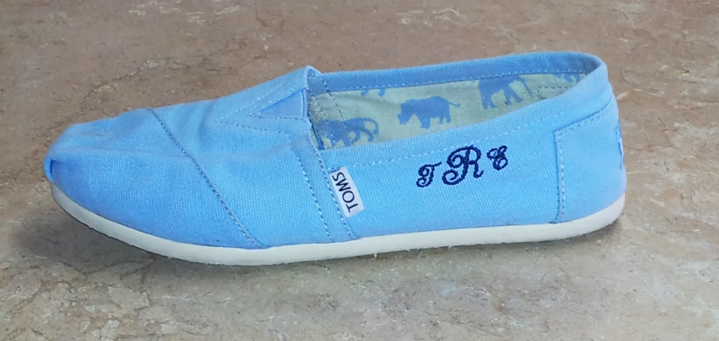 Custom monogram embroidery on canvas shoe.