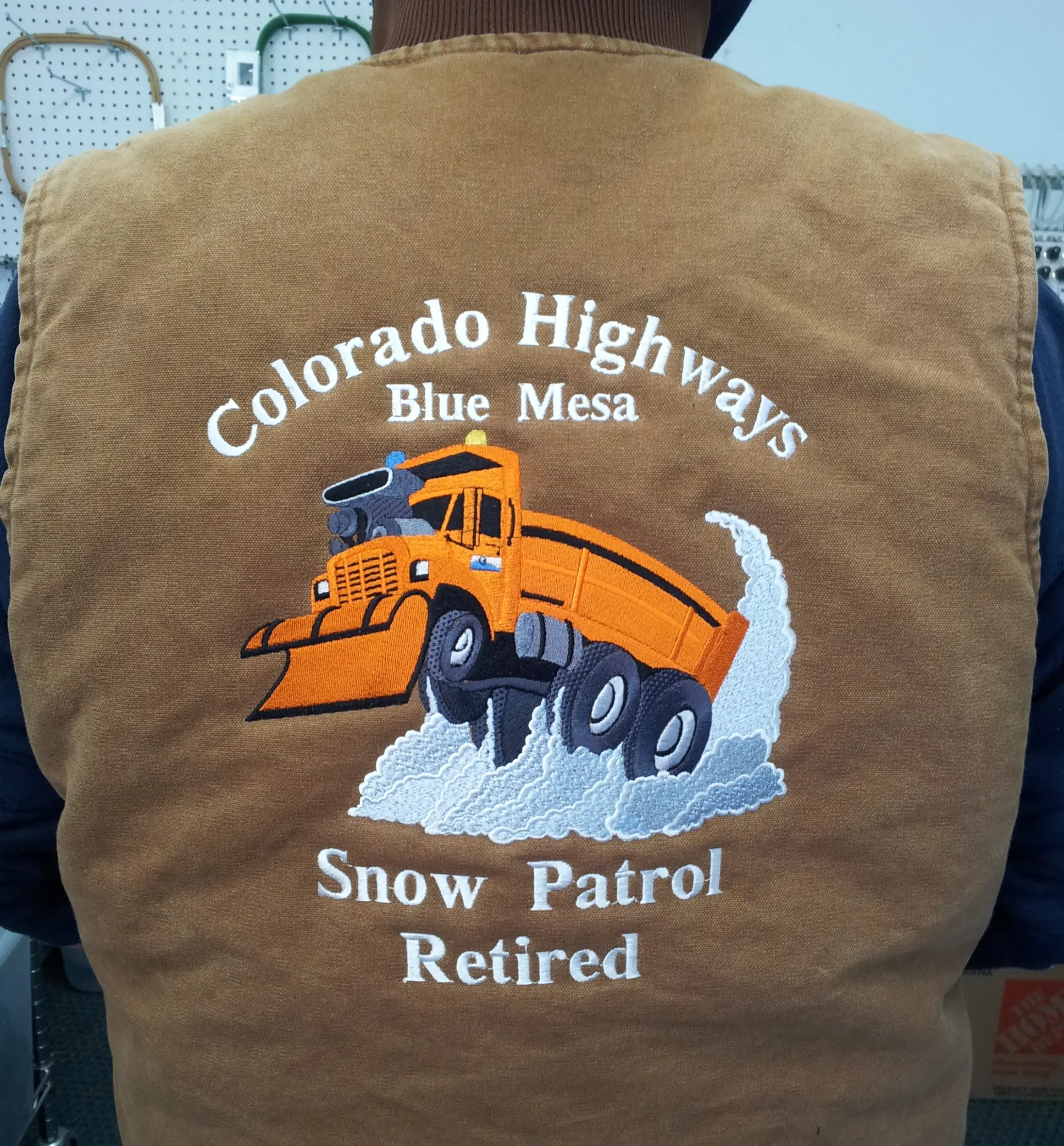 Image of custom embroidered Snowplow jacket back.