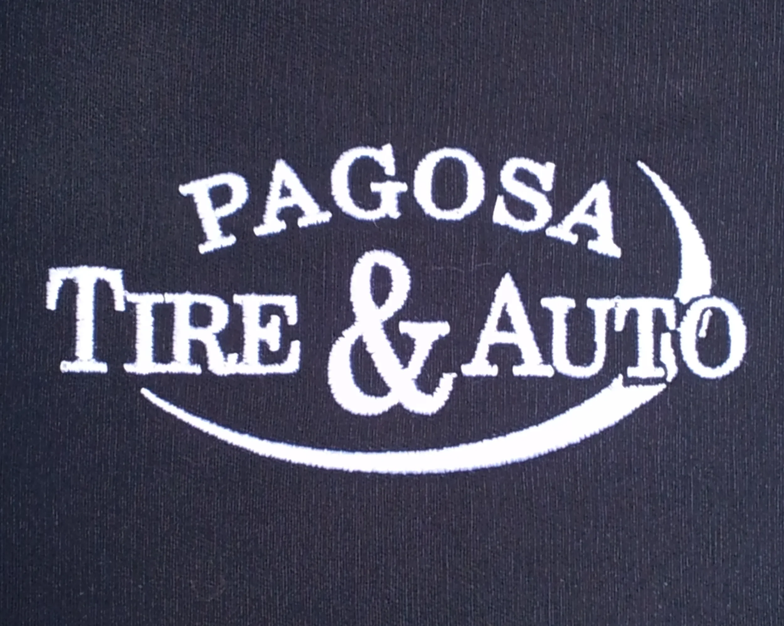 Custom hand digitized shop uniform logo embroidery for Pagosa Tire and Auto.