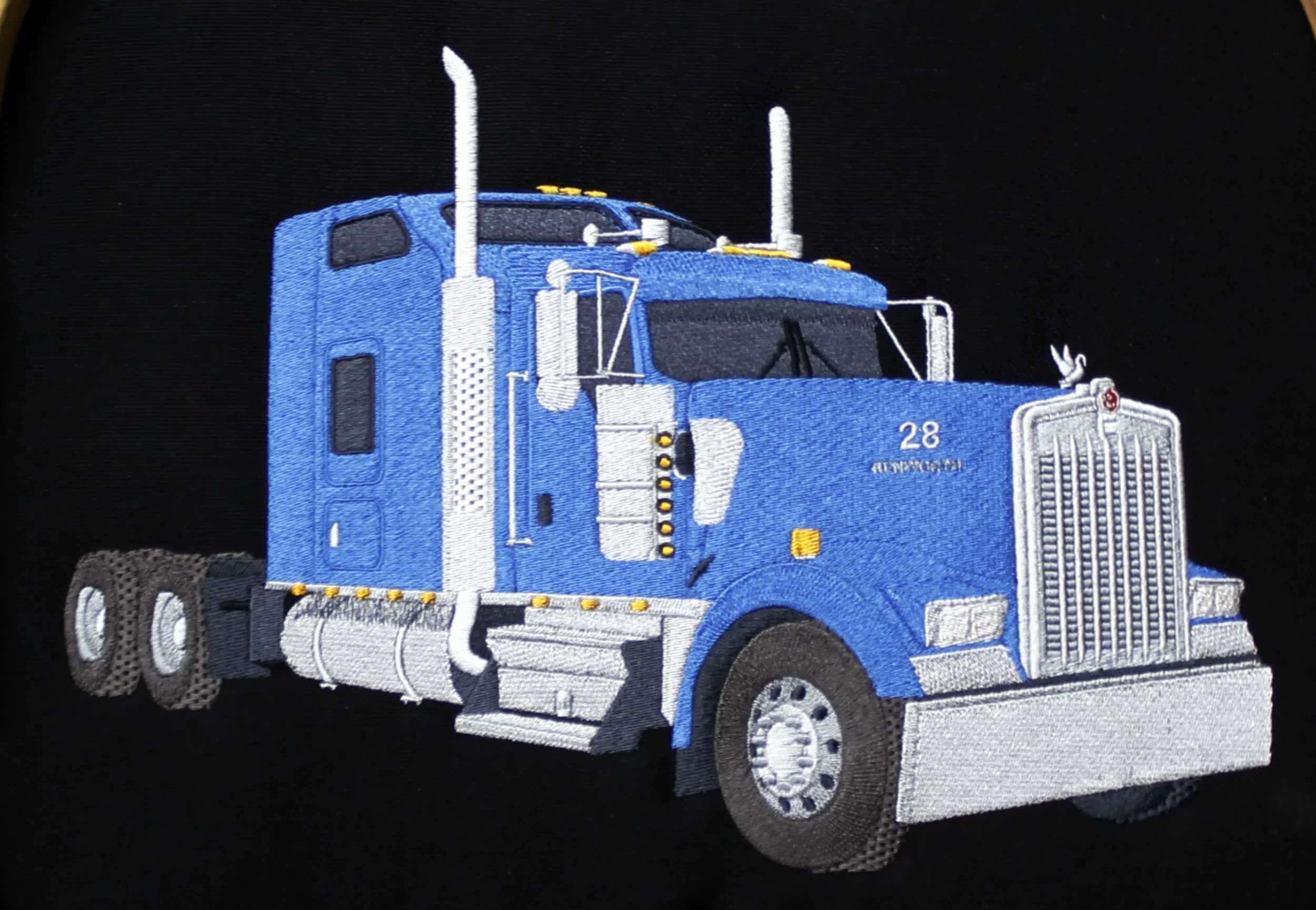 Hand digitized custom embroidery C&C Trucking jacket back.