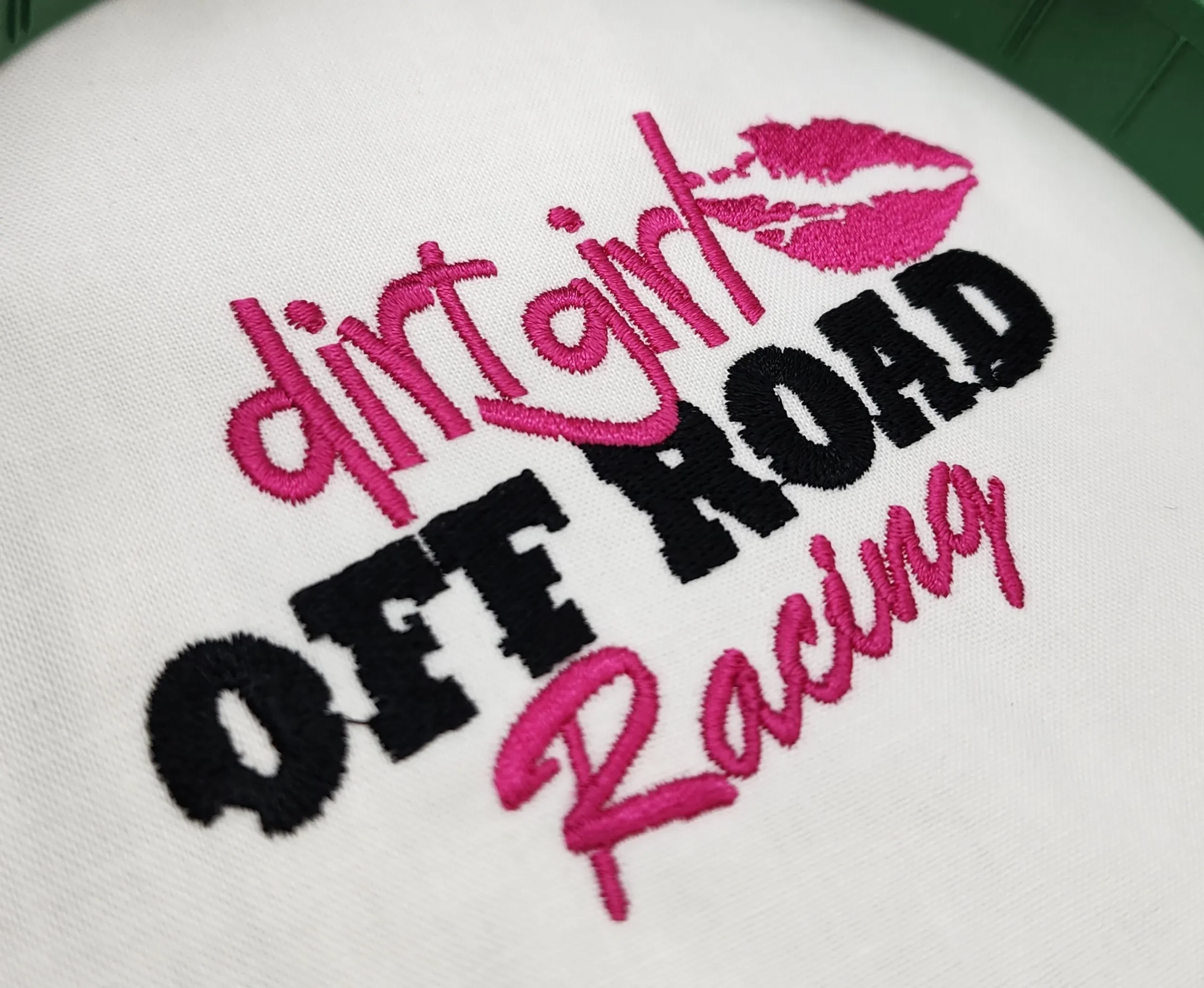 Custom hand digitized Dirt Girl Off Road logo embroidery close up for shirts, jackets, hoodies, caps, and polos.