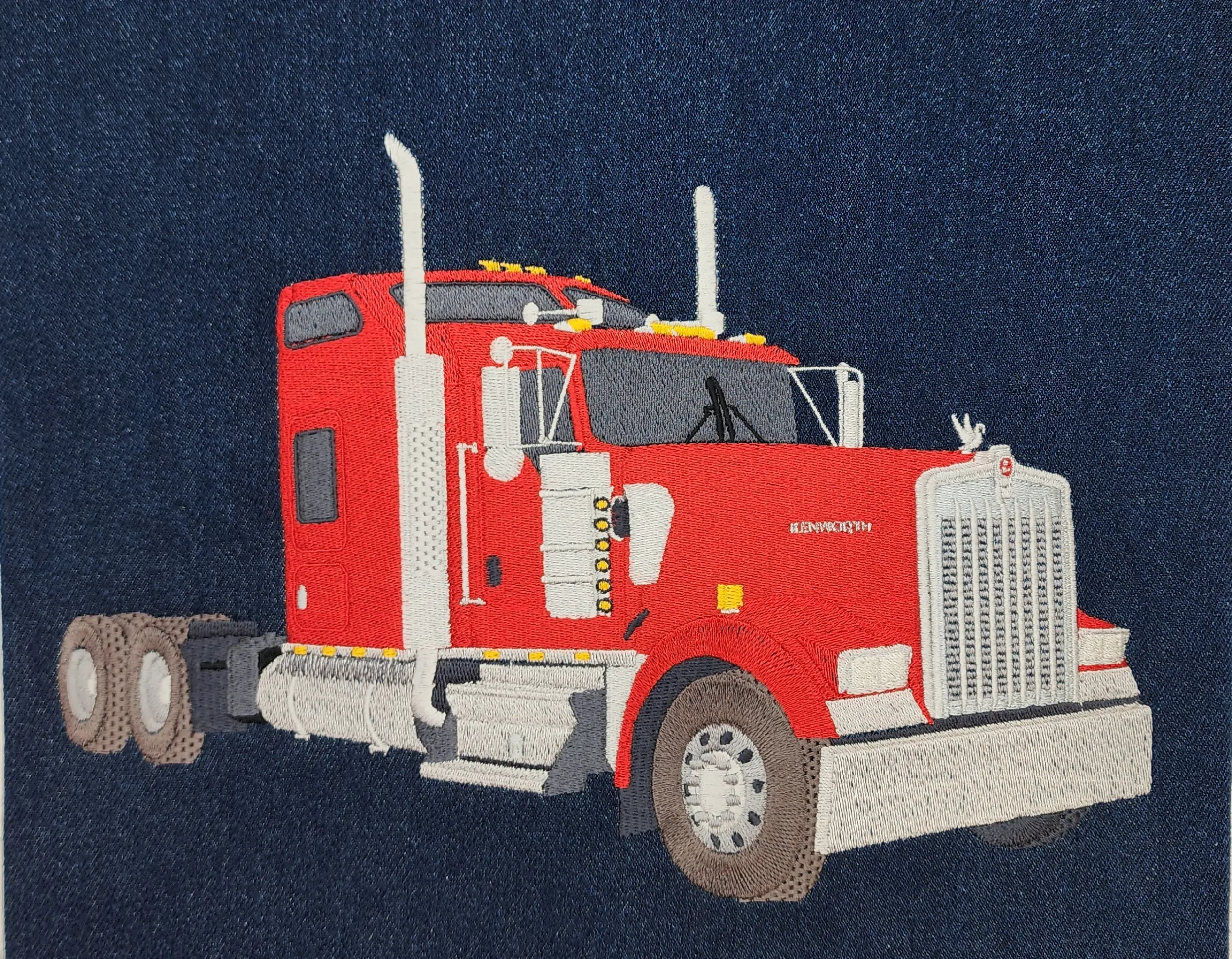 Image of Red semi-truck hand digitized custom embroidery for jacket backs.