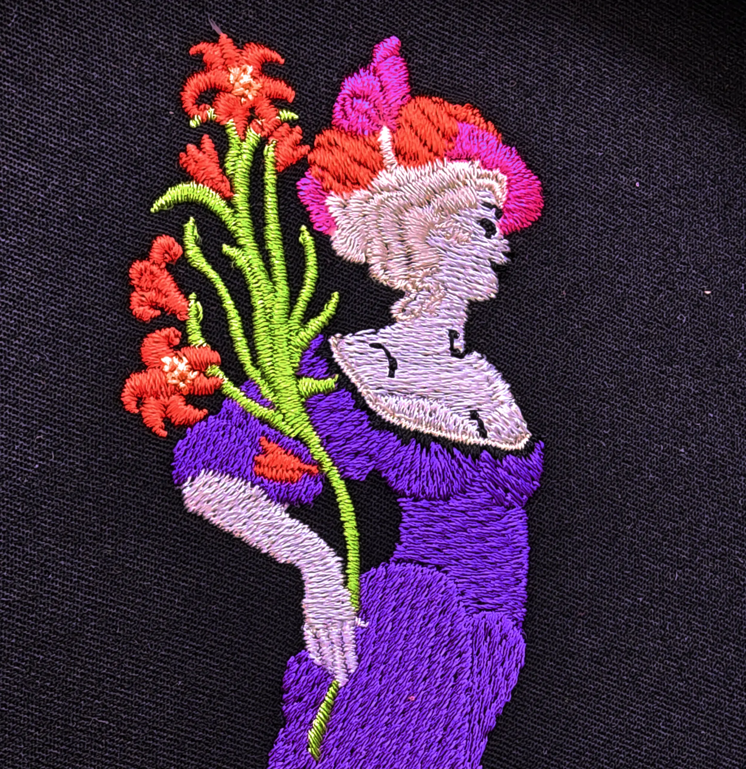 Close-up detail of hand digitized custom embroidery for Floradora Saloon hoodies.