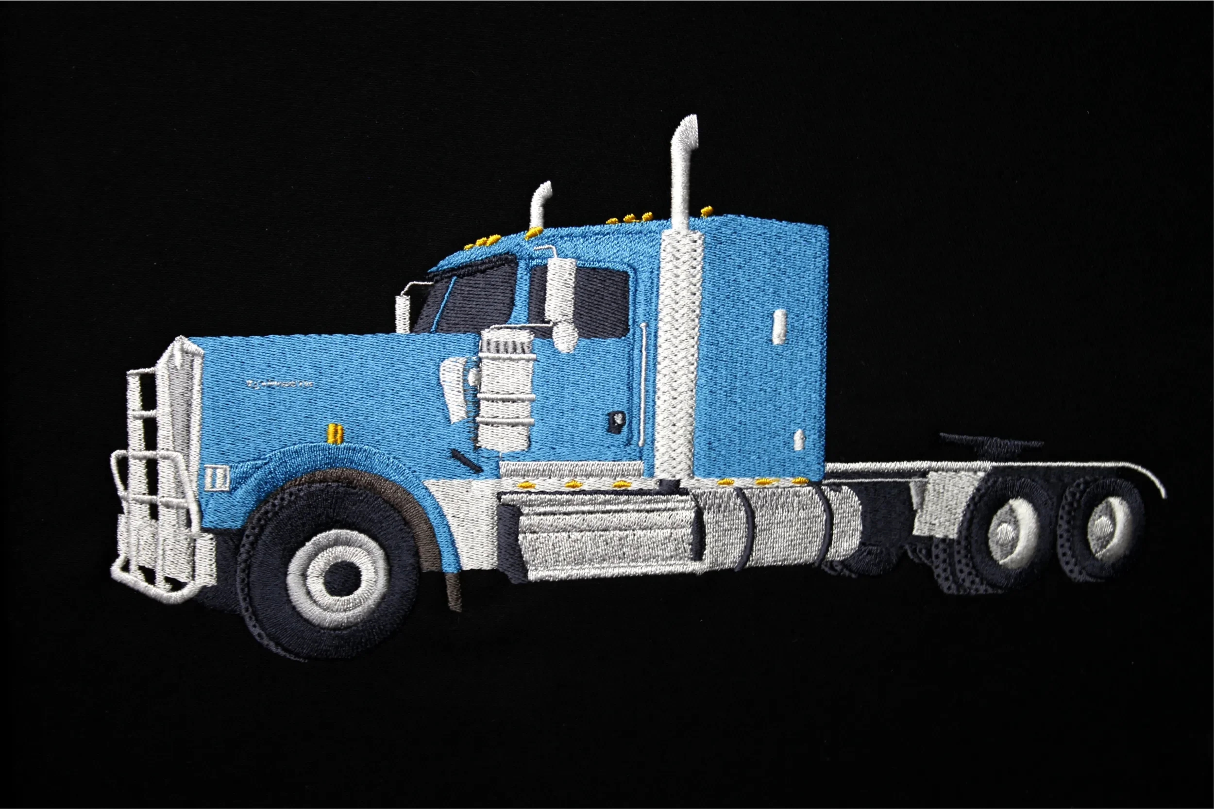 Large custom hand digitized embroidered blue semi-truck jacket back.
