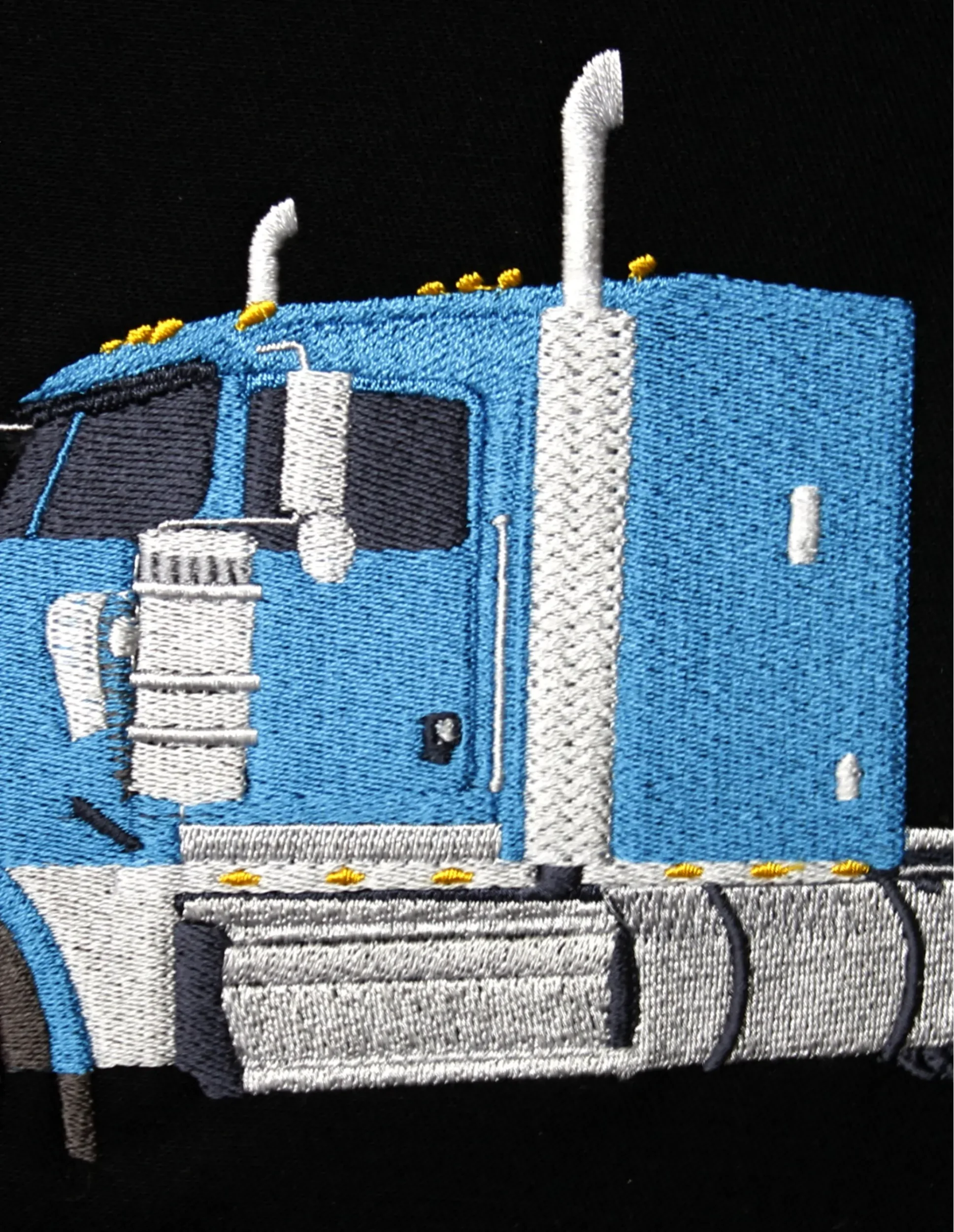 Image of close-up details of blue semi-truck cab.