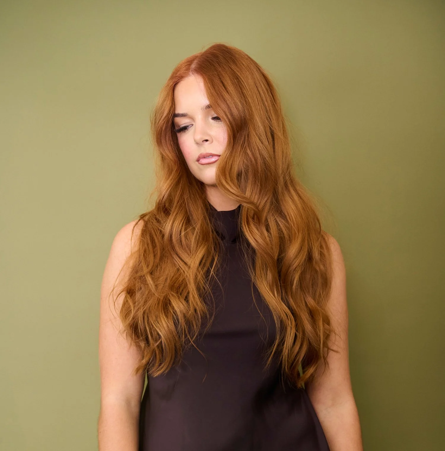 Long, wavy copper-red hair with soft, glossy movement