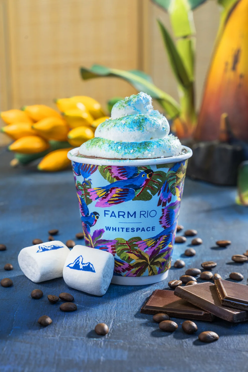 Custom FARM Rio printed hot chocolate cup with blue whipped cream and branded marshmallows