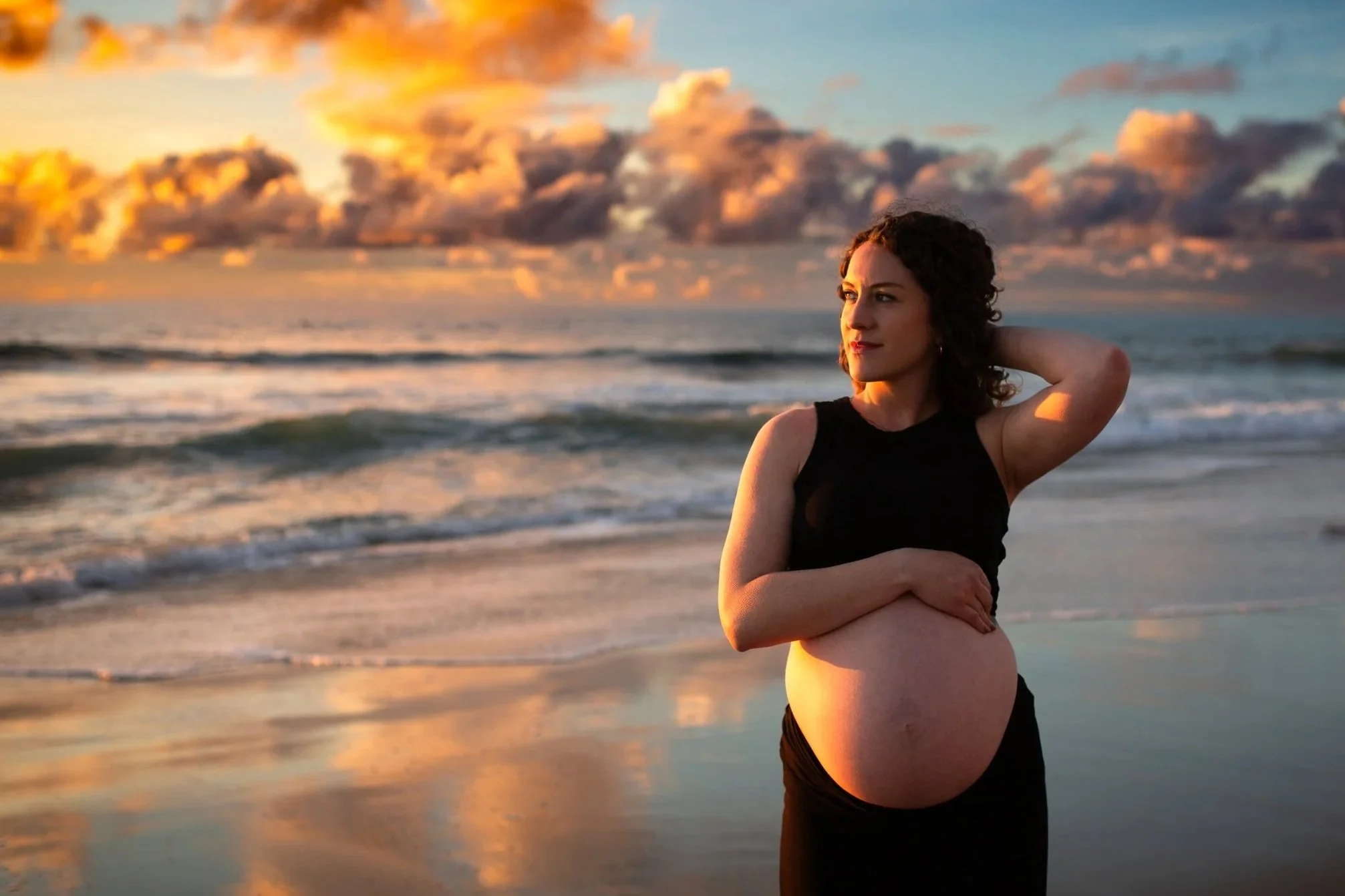 Expecting mother in the water at sunset at Windansea Beach La Jolla, San Diego maternity session