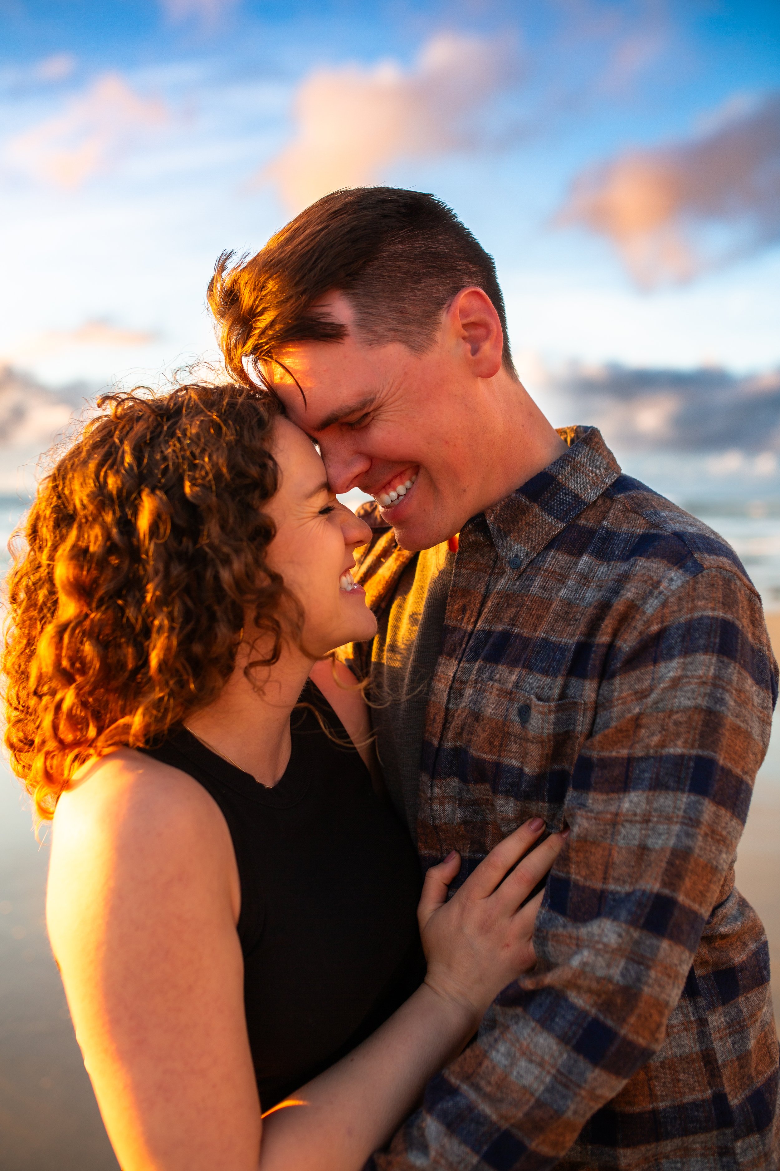 Couple embracing at sunset at Windansea Beach, San Diego couples and family photographer