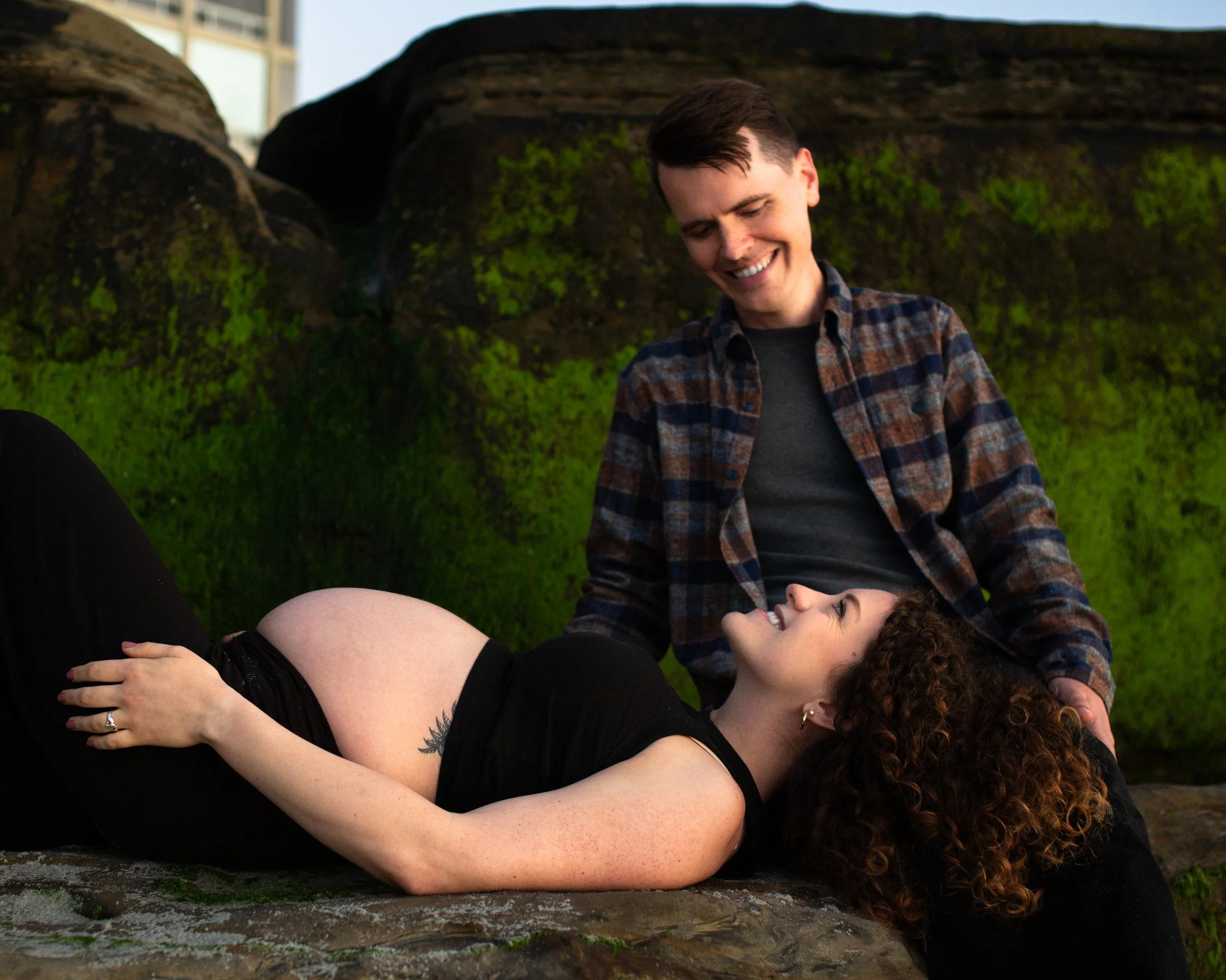 Expecting couple in front of the rocks at Windansea Beach, San Diego maternity photographer