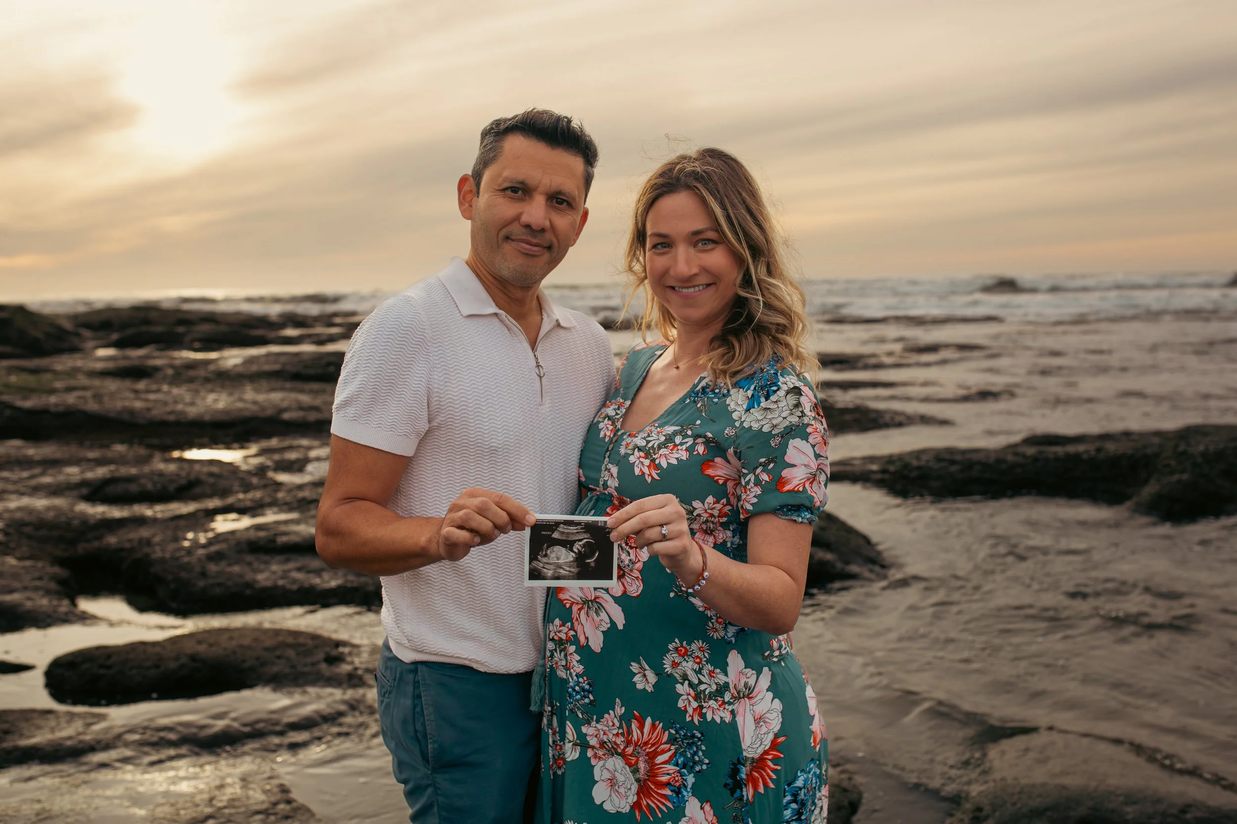Pregnancy announcement photos on the San Diego coast