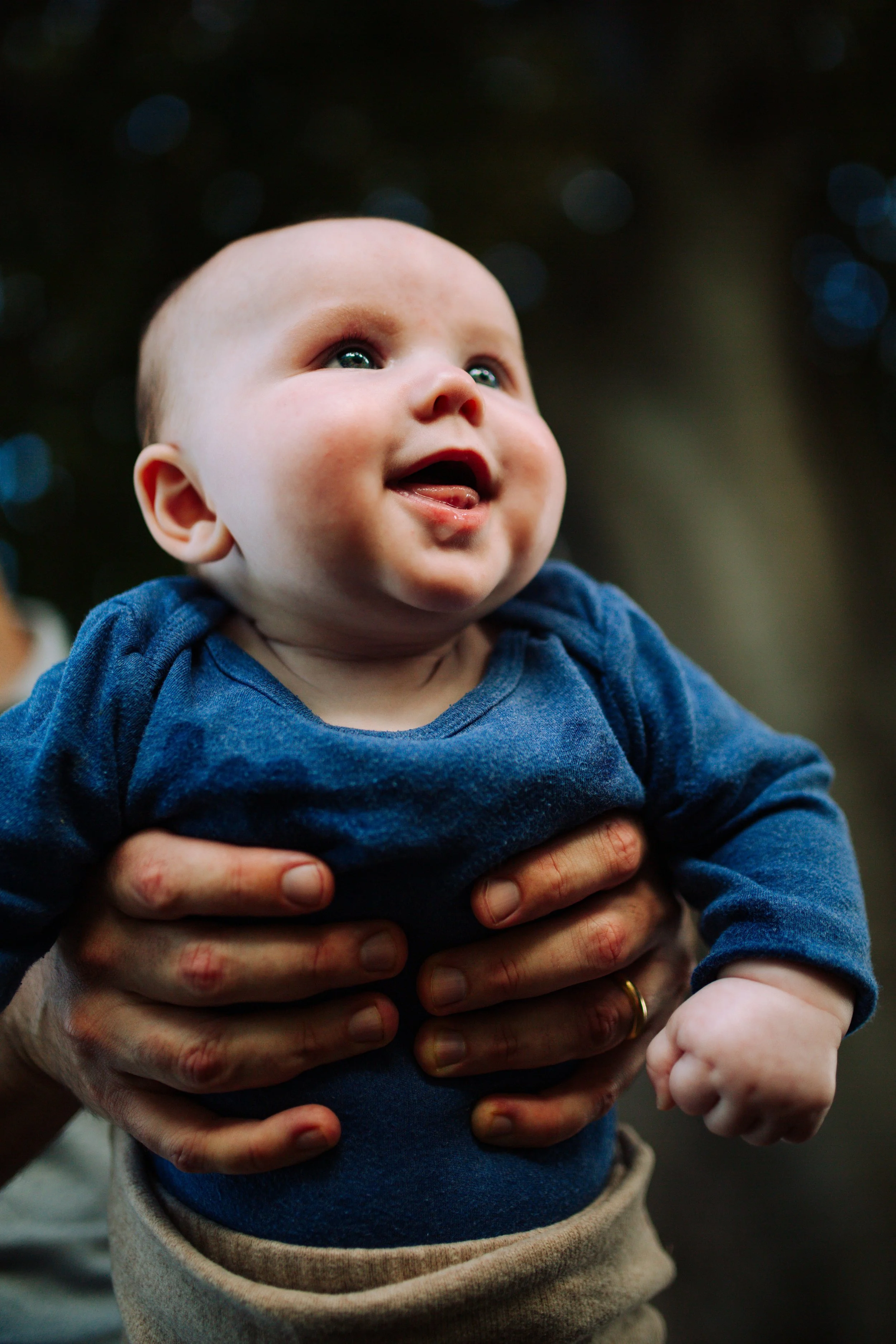 Smiling baby being held up during a family session, San Diego family photography
