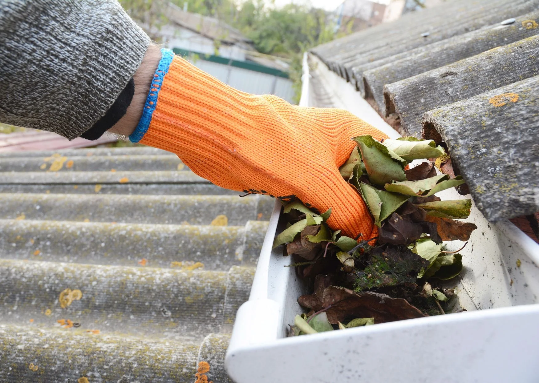 person-cleaning-out-roof-gutter-a7d758c873274953bd00f9dfd35b665d.jpg