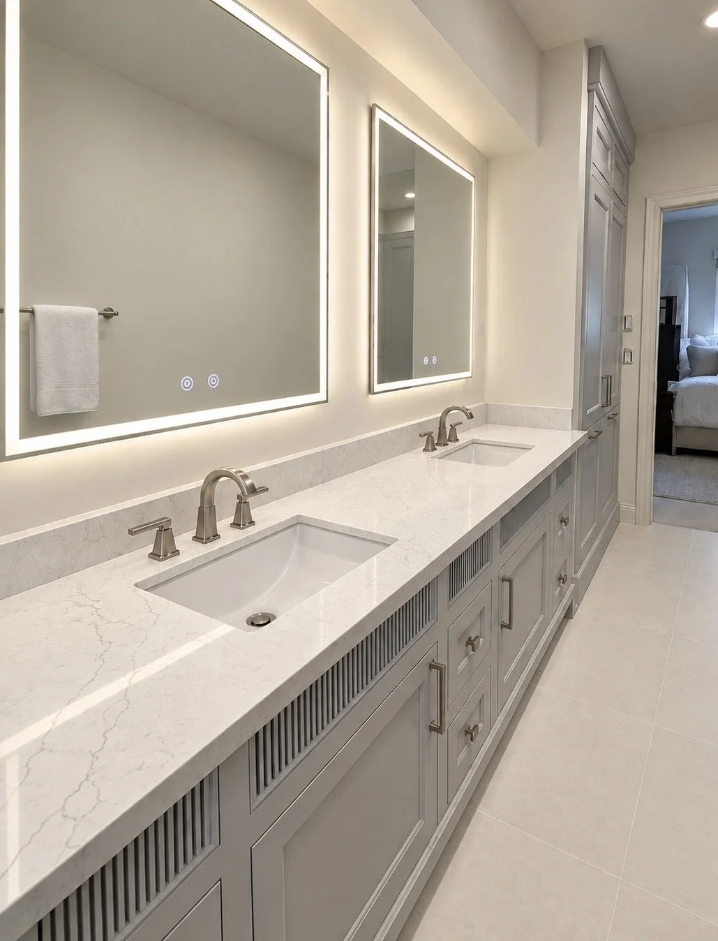 Double vanity bathroom with two mirrors, dual sinks, marble countertop, built-in cabinets, and a doorway to a bedroom.