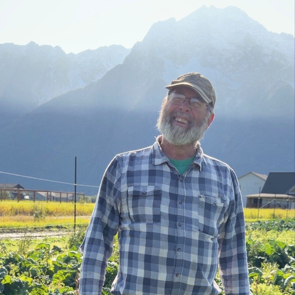 Tom Bergey on his farm in Butte, Alaska in front of Pioneer Peak