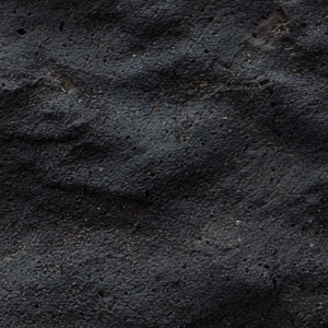 Close-up of dark, textured soil or dirt.