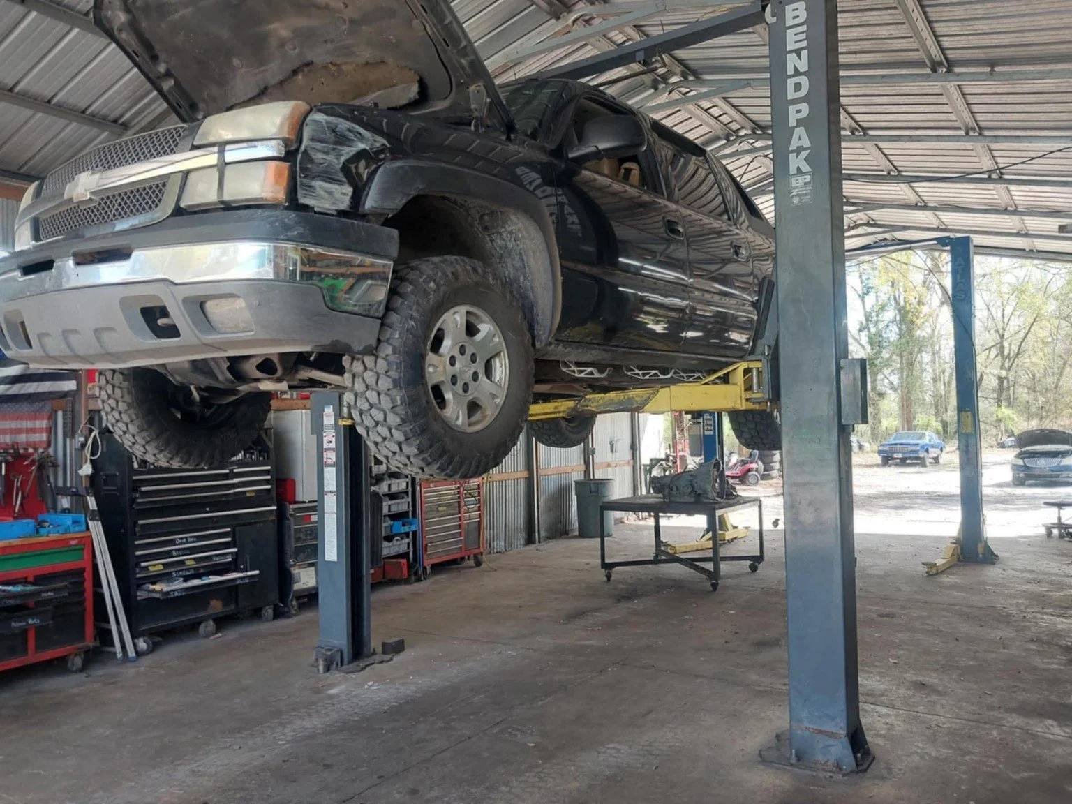 Truck on a lift inside Phinney Automotive