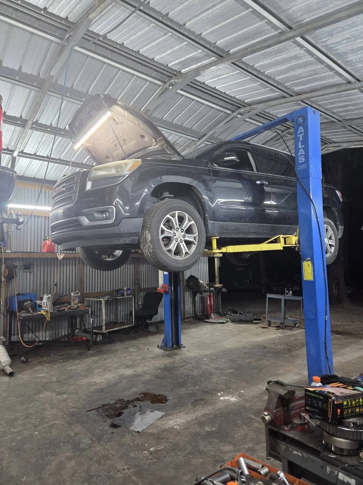 SUV on lift with transmission out at Phinney Automotive