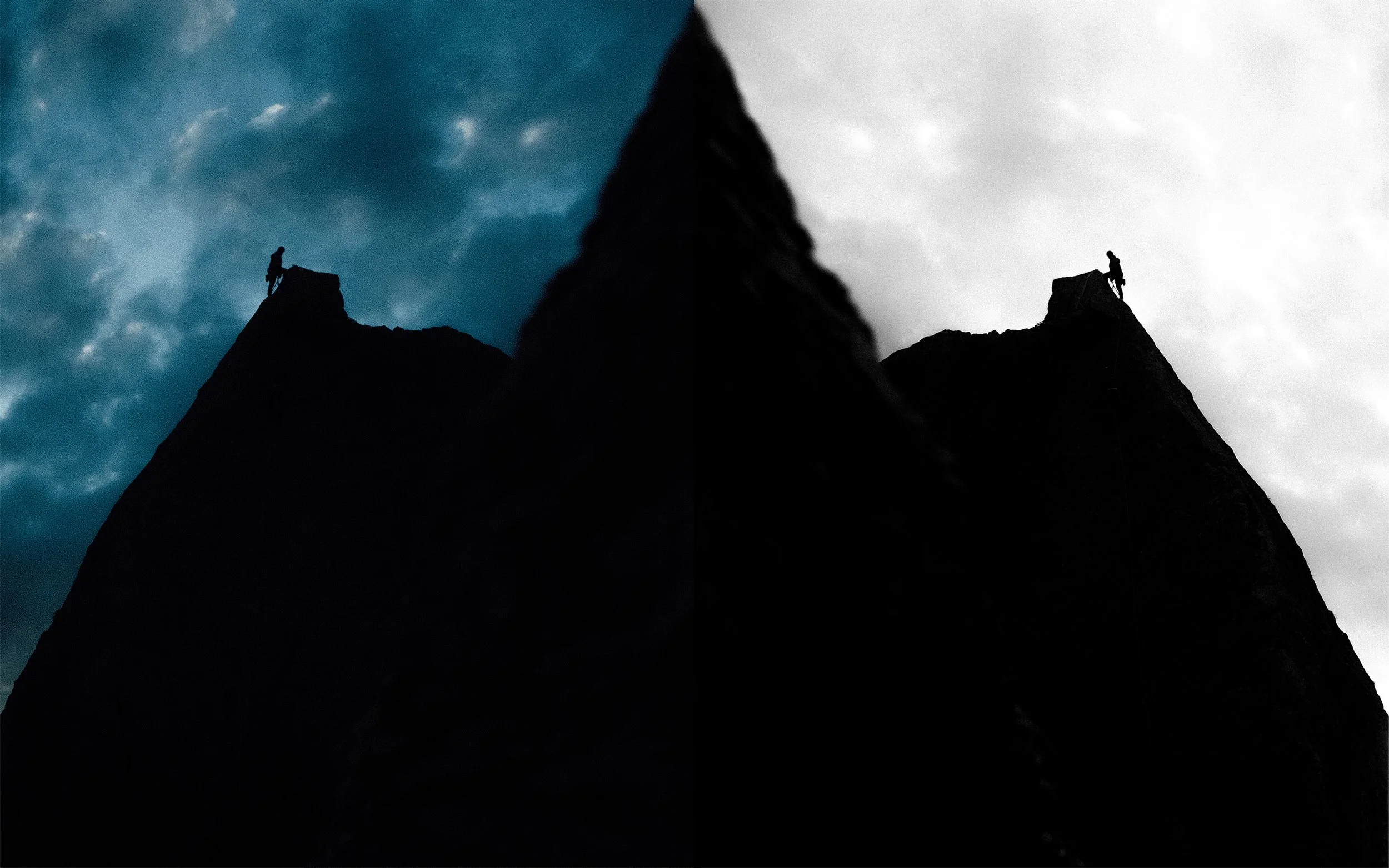 Une silhouette de grimpeur sur une falaise abrupte, avec un ciel partiellement nuageux en arrière-plan, la moitié gauche de l'image étant plus sombre et la moitié droite plus claire.