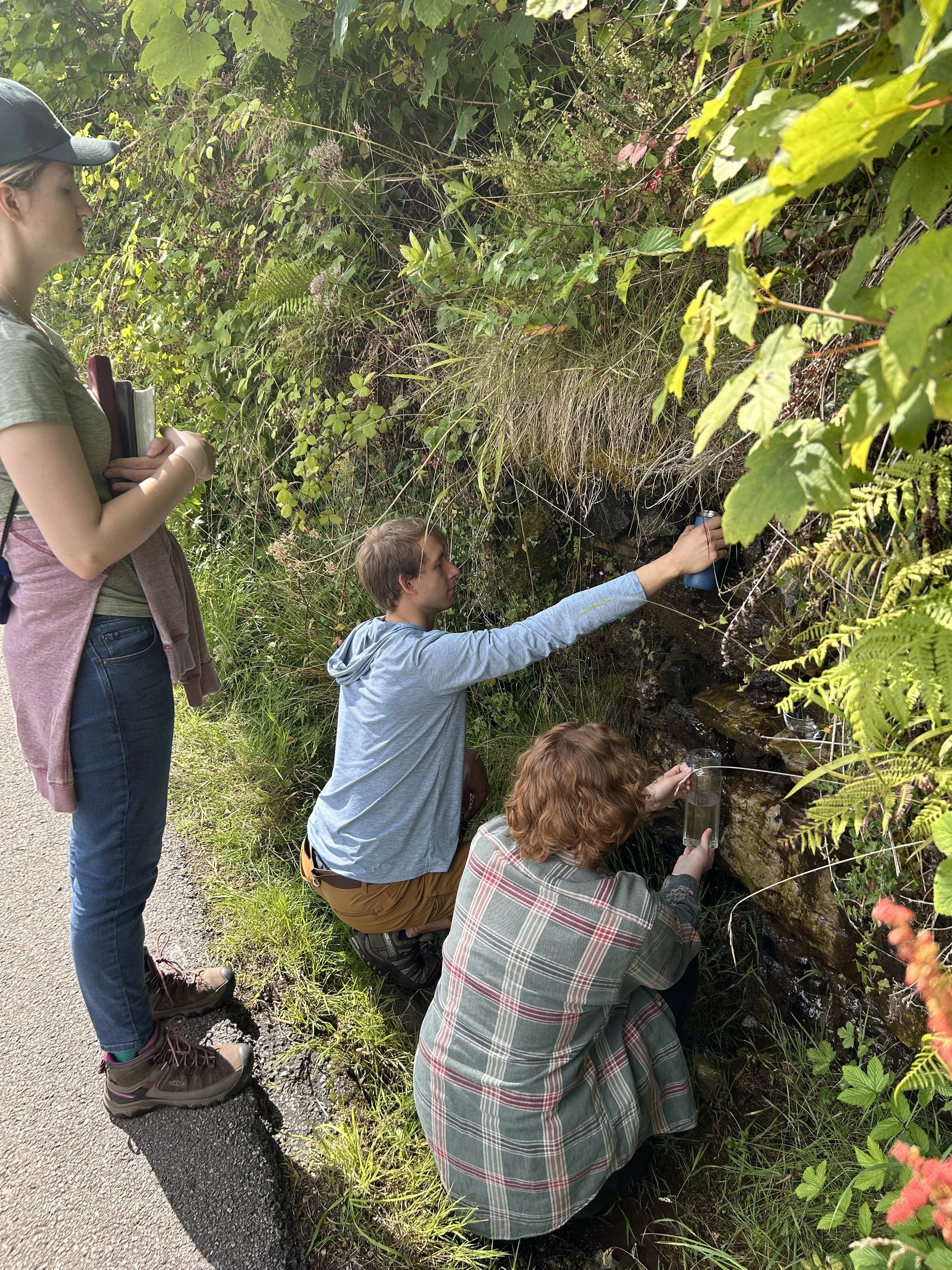 People taking water from St. Columba's Well