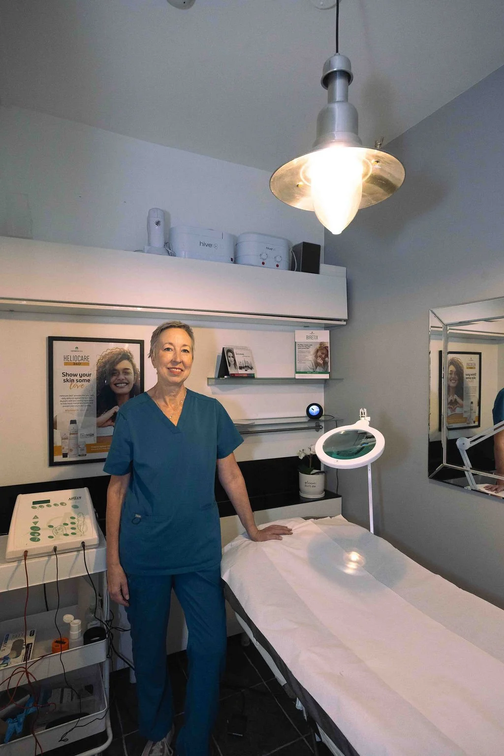 Sarah Hurst standing beside the treatment bed and Advanced Electrolysis equipment at Turn Beautiful in Brighton.