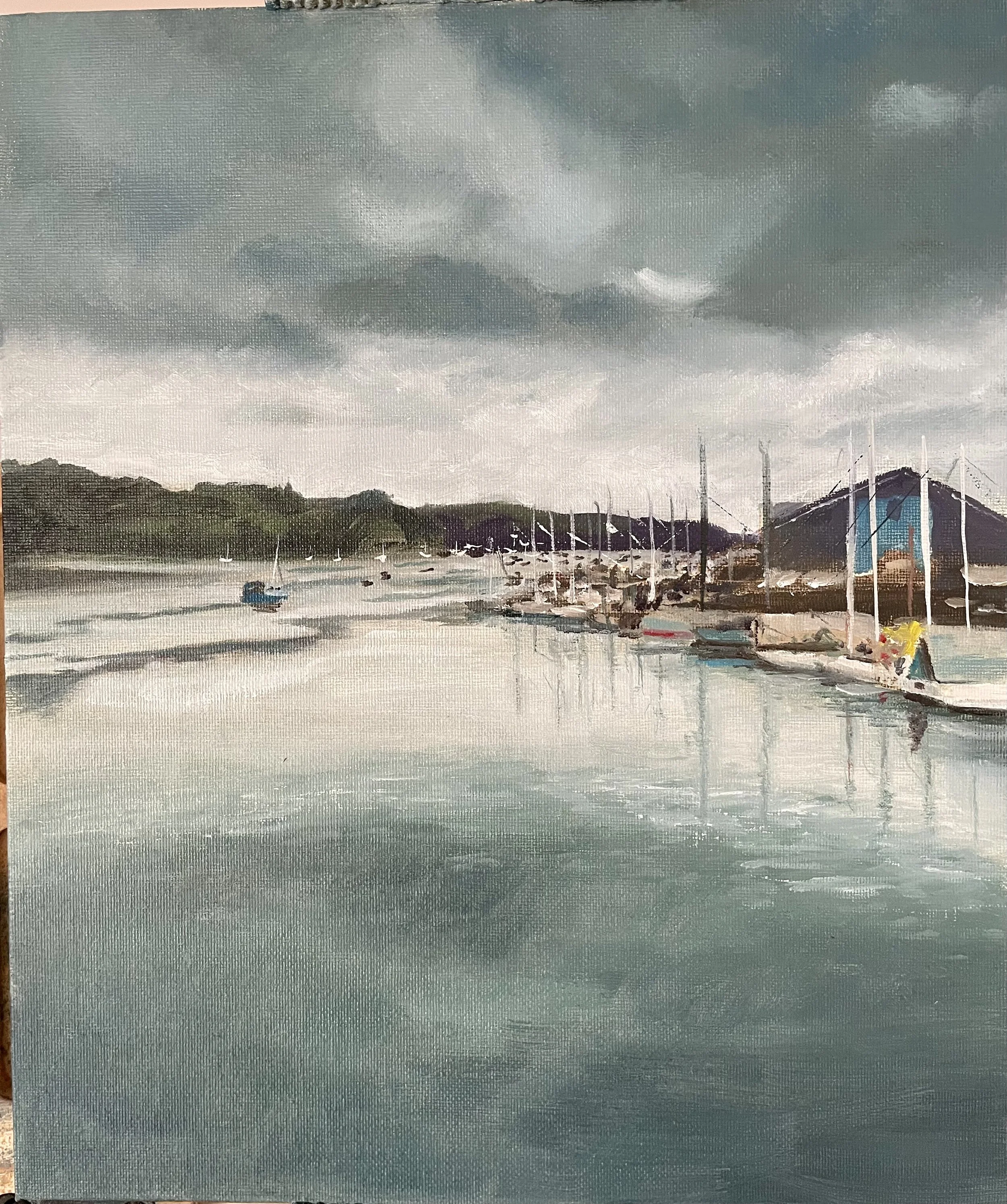 Oil painting of a moody sky over the Penryn River, Cornwall with boats and the marina in the distance.