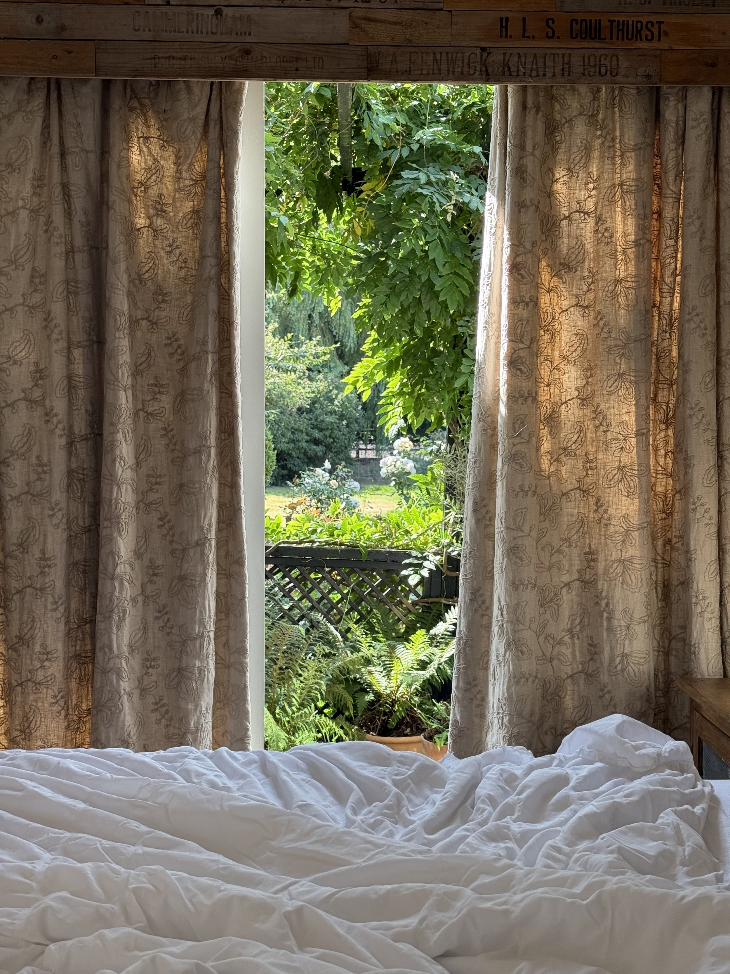 Looking through the curtains towards the hot tub featured on the private patio
