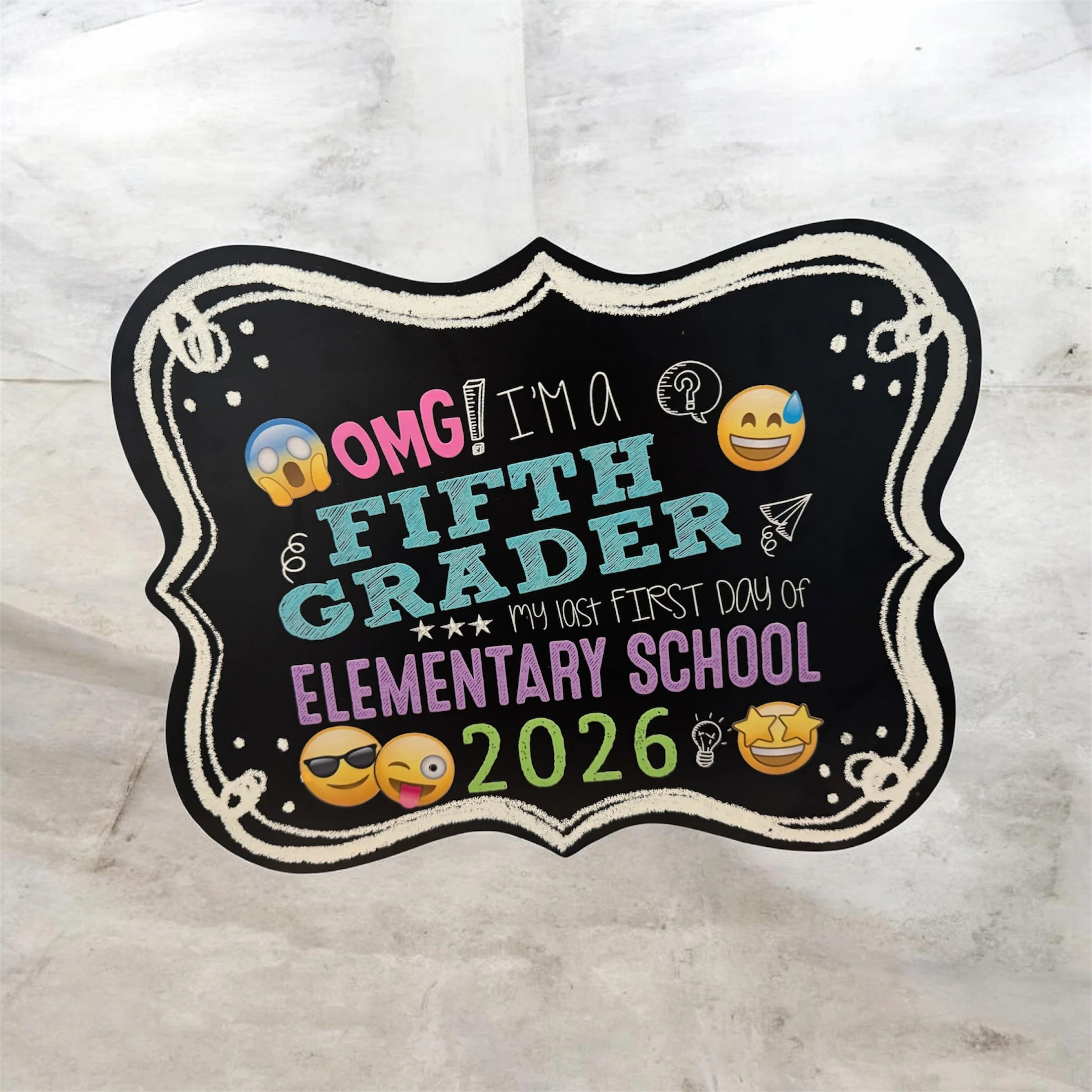 Decorative chalkboard sign with colorful text and emojis, celebrating a child's school first day in August 2026.