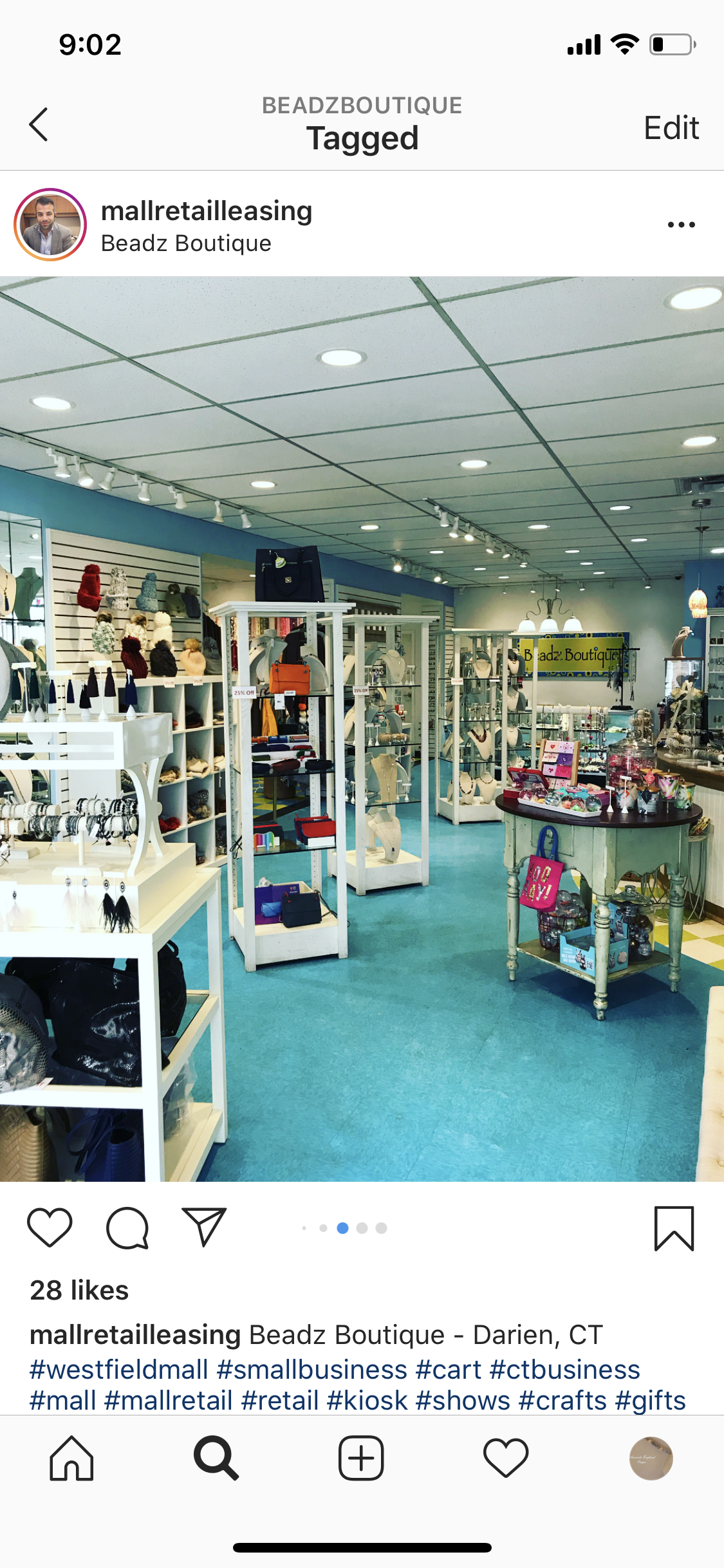 Interior of a small retail store with displays of jewelry, handbags, and accessories, with the store name Beadz Boutique visible.