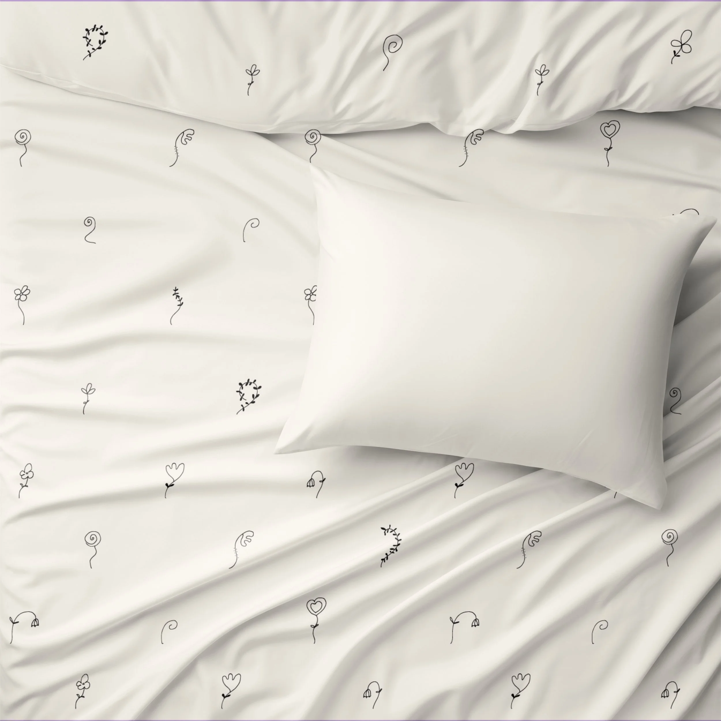 Little Whispers sheet set with tiny hand drawn black floral motifs scattered across soft cream bedding.
