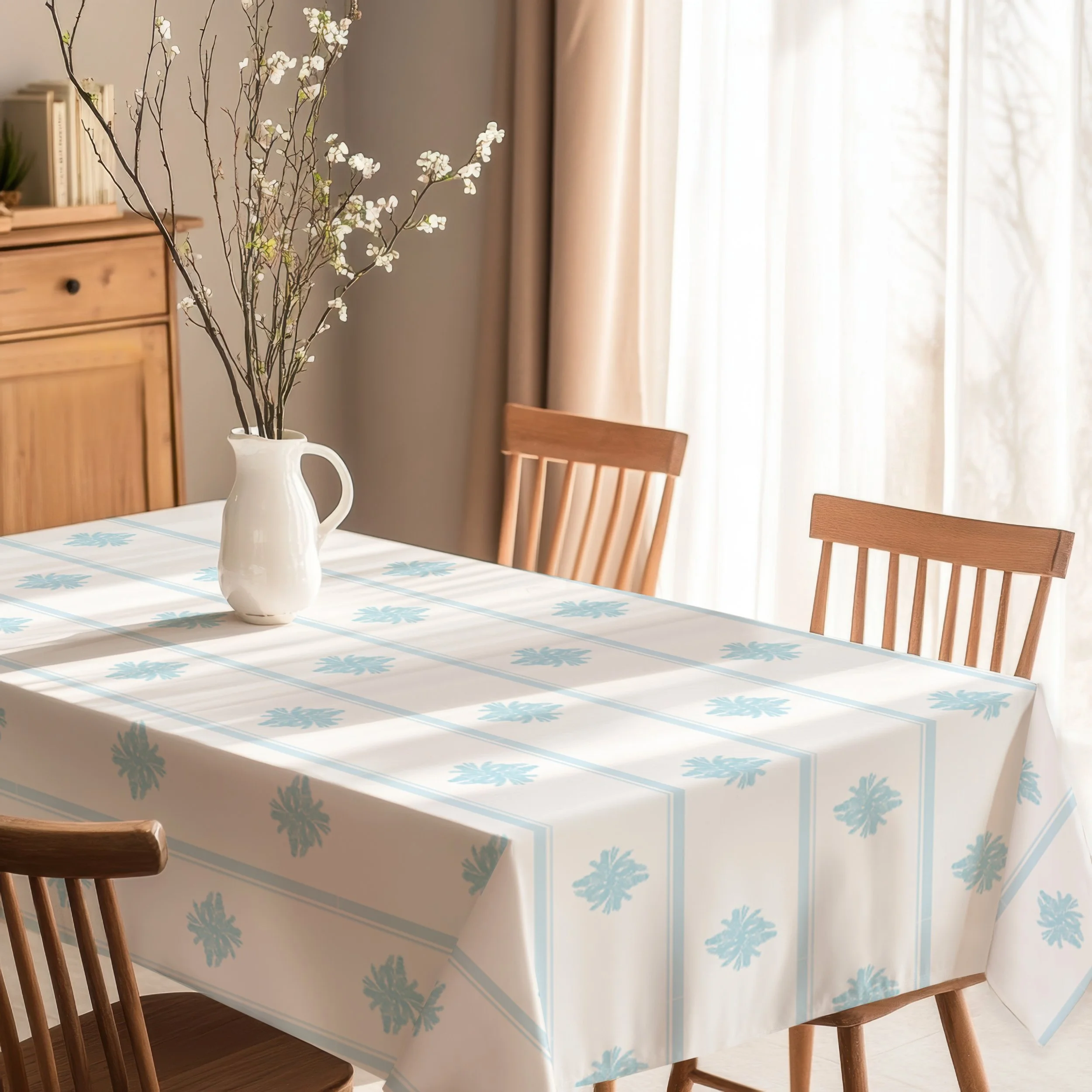Provence Morning tablecloth with soft aqua botanical stripes in a warm, light filled dining room.