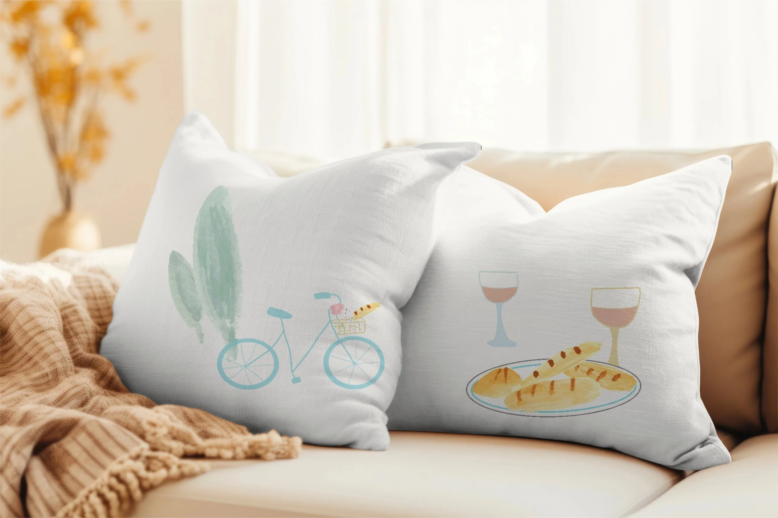 La Belle Vie throw pillows with playful French inspired bicycle, wine and baguette illustrations.