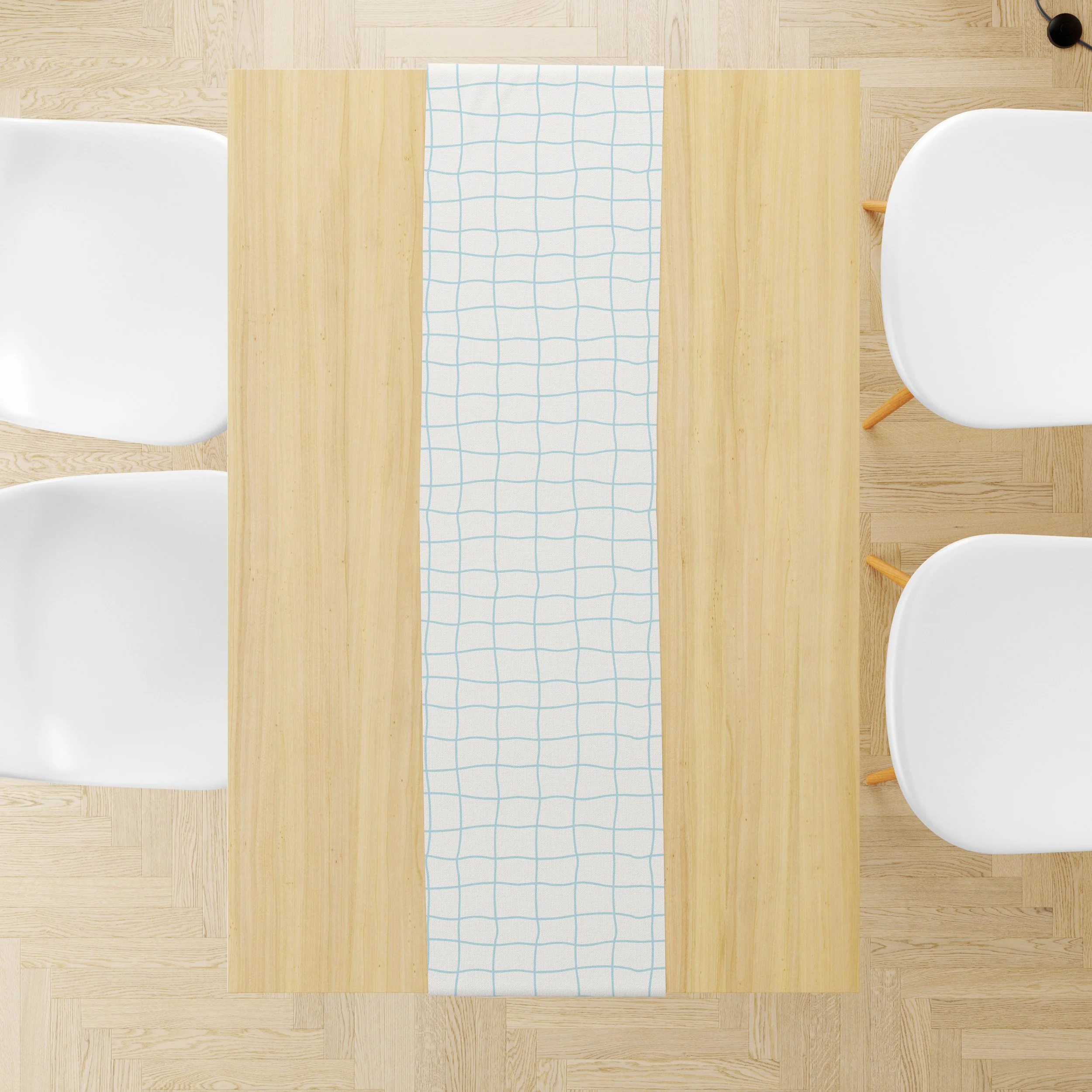 Café Checks table runner with a hand drawn aqua grid pattern on a natural wood dining table.
