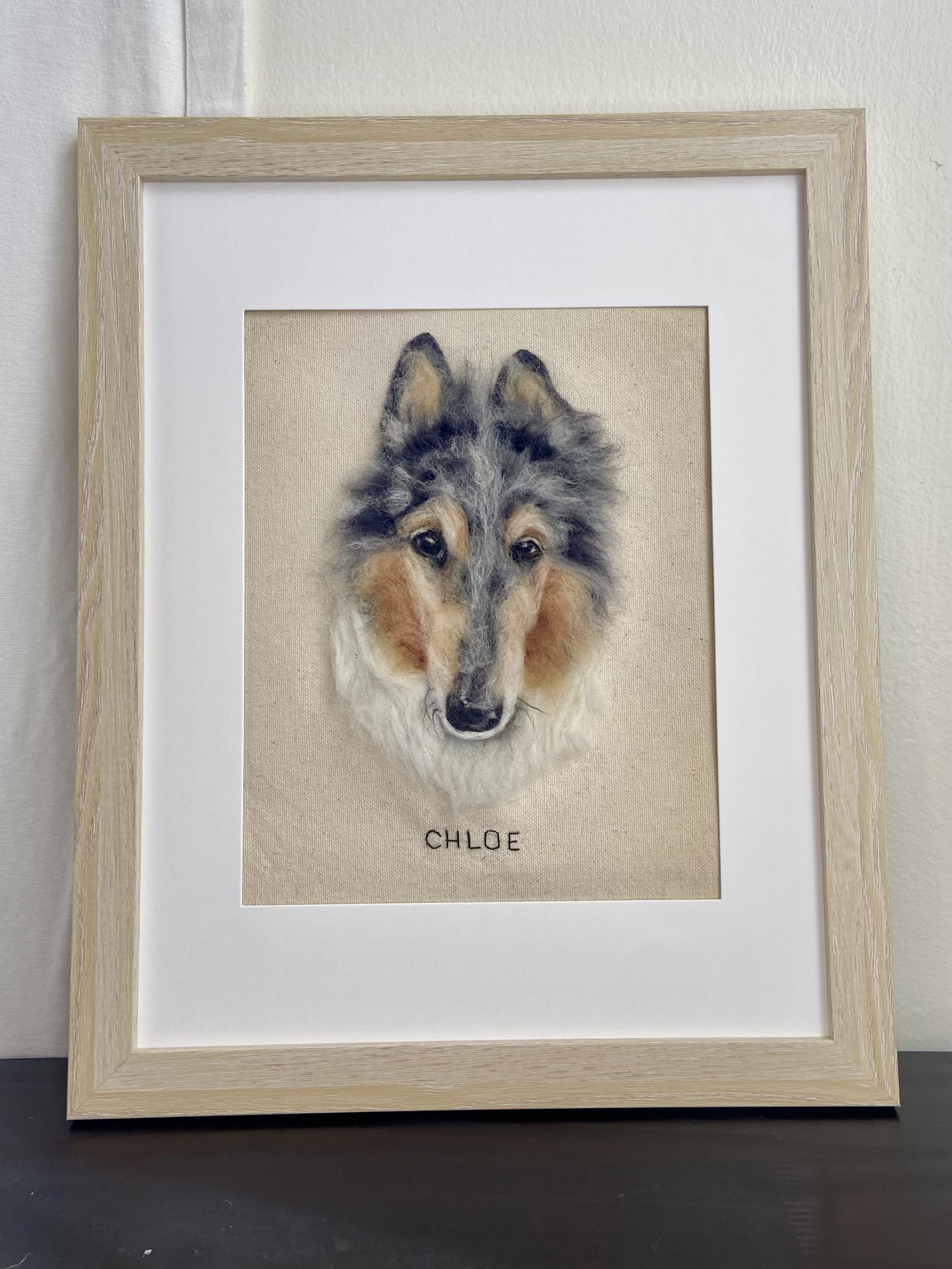 Framed watercolor painting of a wolf's head, with the name "Chloe" written underneath.